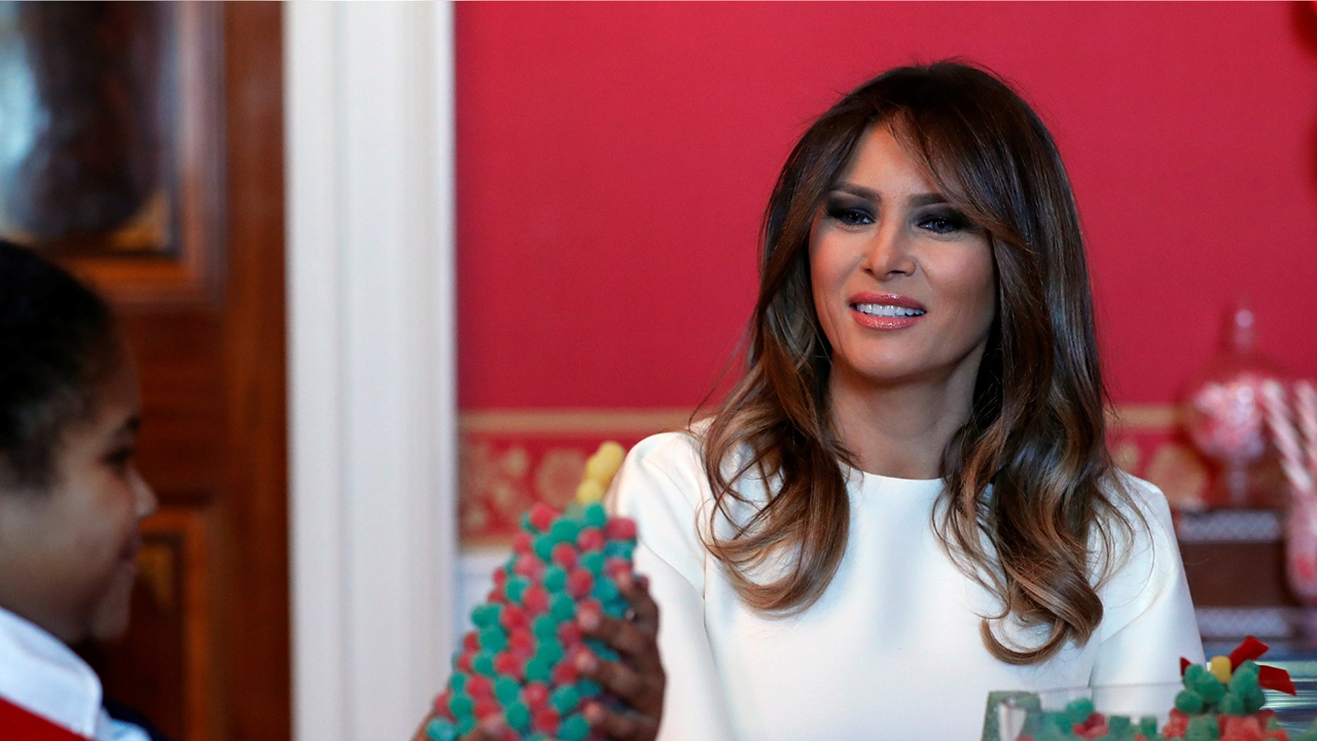 First lady Melania Trump visits with children in the Red Room working on holiday treats among the 2017 holiday decorations with the theme "Time-Honored Traditions" at the White House in Washington, Monday, Nov. 27, 2017. The First Lady honored 200 years of holiday traditions at the White House.