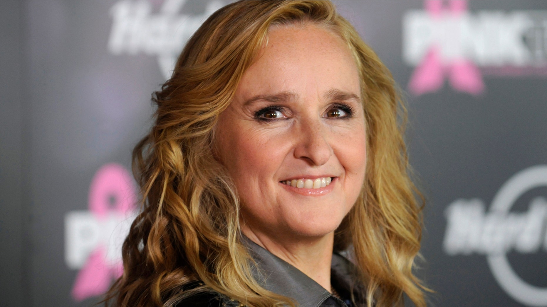 Melissa Etheridge poses for photographers after receiving a star on the Hollywood Walk of Fame in Los Angeles September 27, 2011.