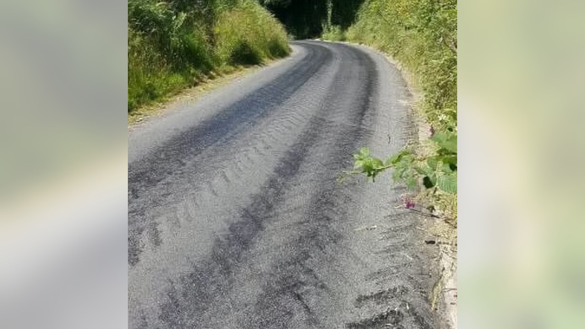 The current state of the road from Heasley Mill, near North Molton, Devon. See SWNS story SWMELT; Gritters could soon be back out on UK roads - after dramatic pictures showed they were starting to MELT. The heatwave has caused tarmac to start disappearing as the soaring temperatures on the road hit 50 degrees. And this could see councils back deploying gritters on the road to spread sand - effectively a sunscreen for the surface. Images of the melted roads have been shared by the staff of the Communication Workers Union as a warning to try and keep members of the public on the roads safe.One was taken by a post office worker on Exmoor, which shows the current state of the road from Heasley Mill, near North Molton, Devon, while other images of Woodbury Salterton in Devon, melting have also been circulated.