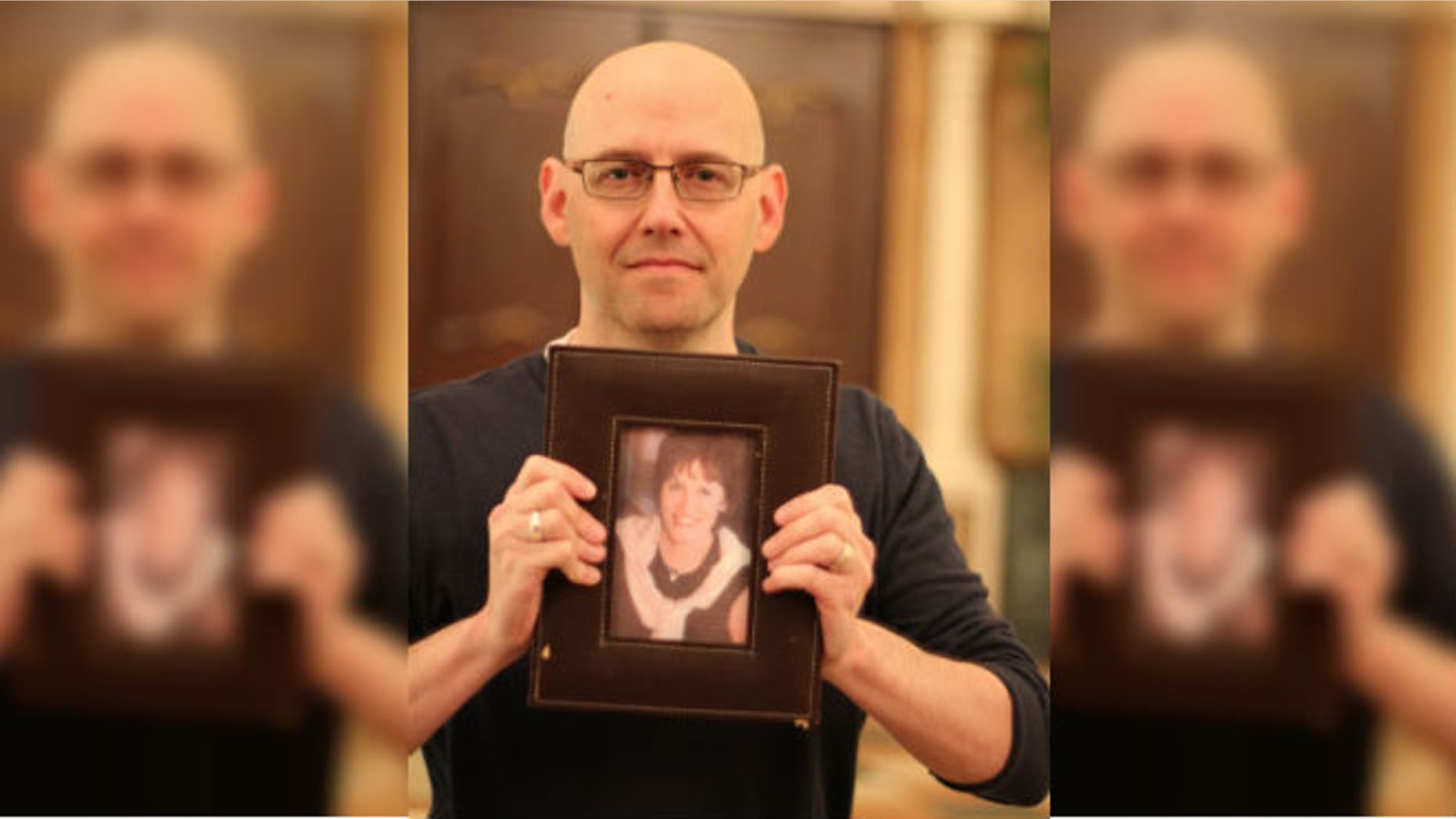 Best-selling author Brad Meltzer holding a photo of his high school teacher, Ellen Sherman. Meltzer used social media to find a kidney donor for Sherman. (Credit: Ryan Kuttler)