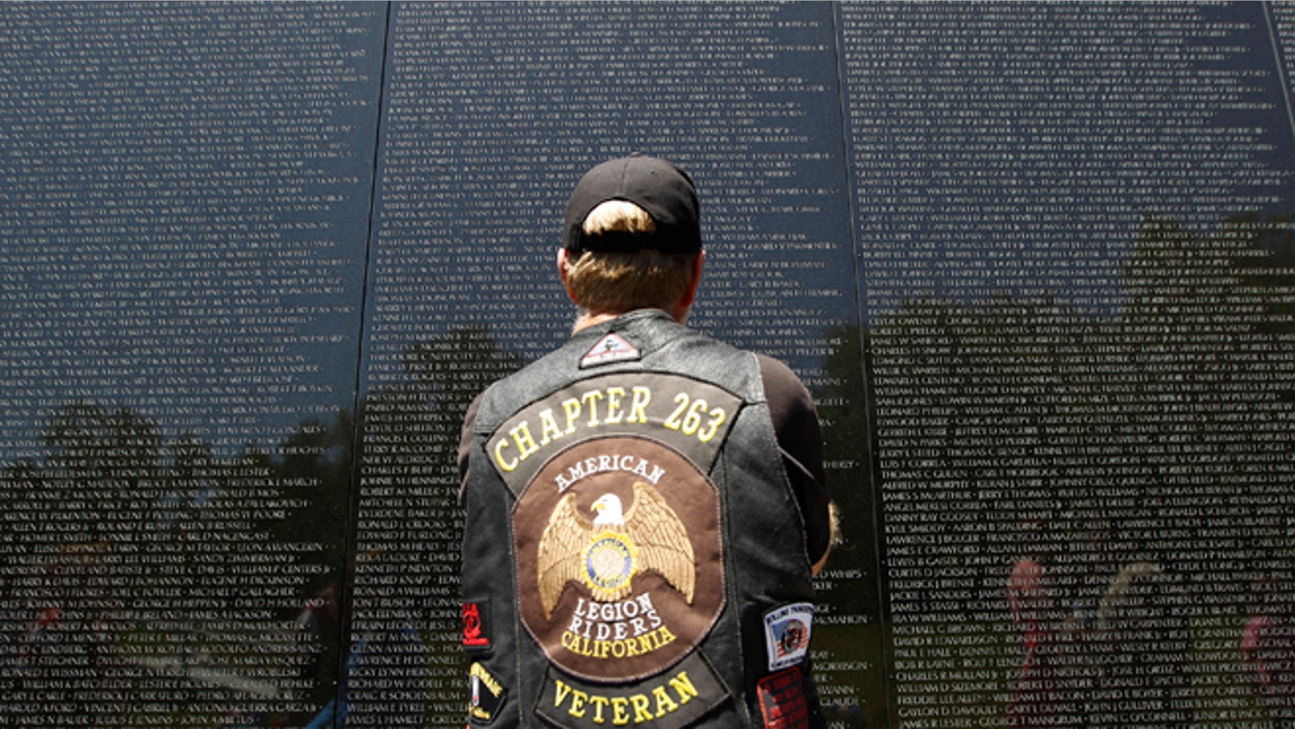 May 26, 2013: A veteran looks at the names of those who died etched into the wall of the Vietnam Veterans Memorial, ahead of Memorial Day in Washington, Sunday.