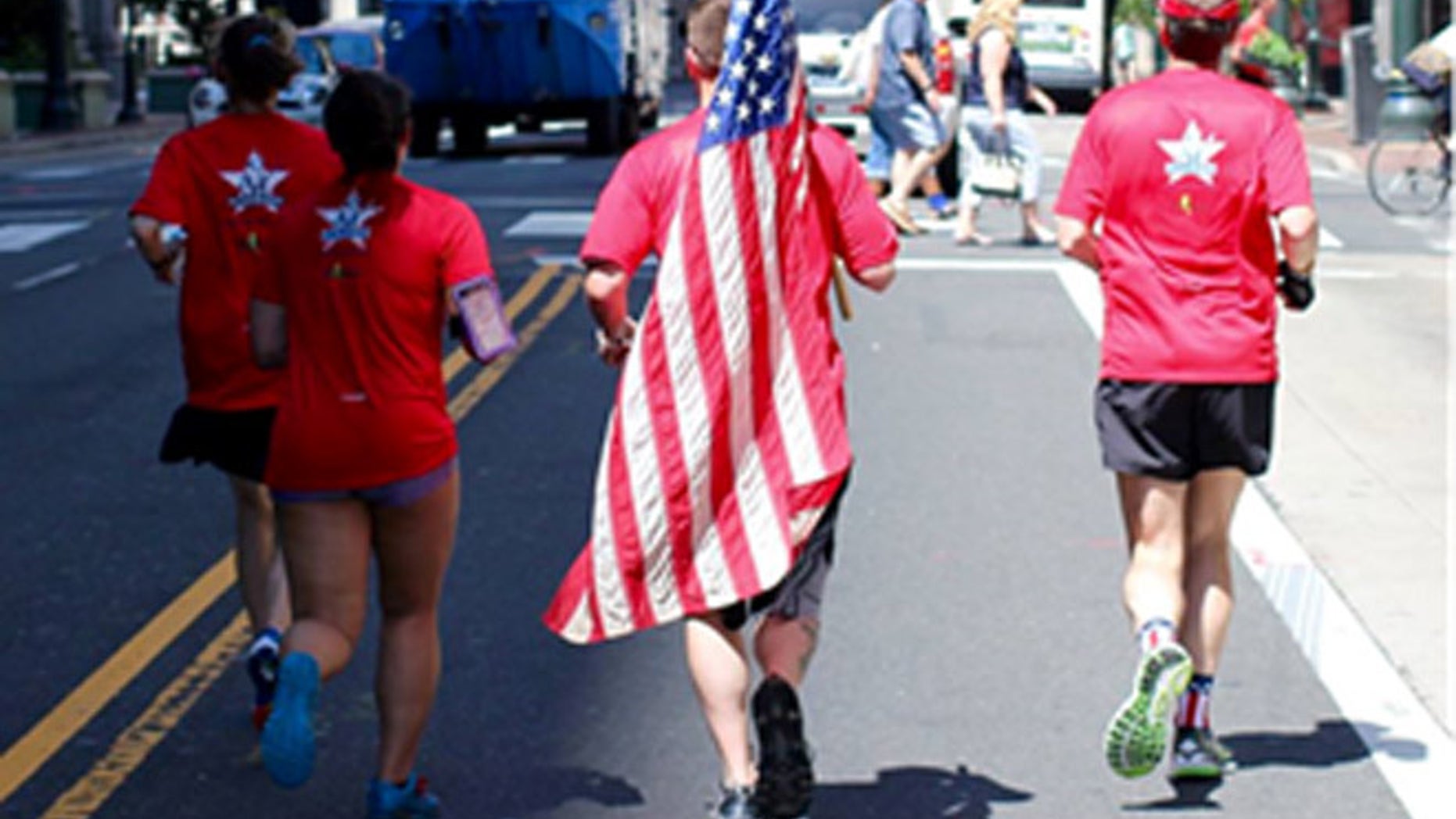 The flag on its way to the handoff on Philadelphia's historic Rocky steps.