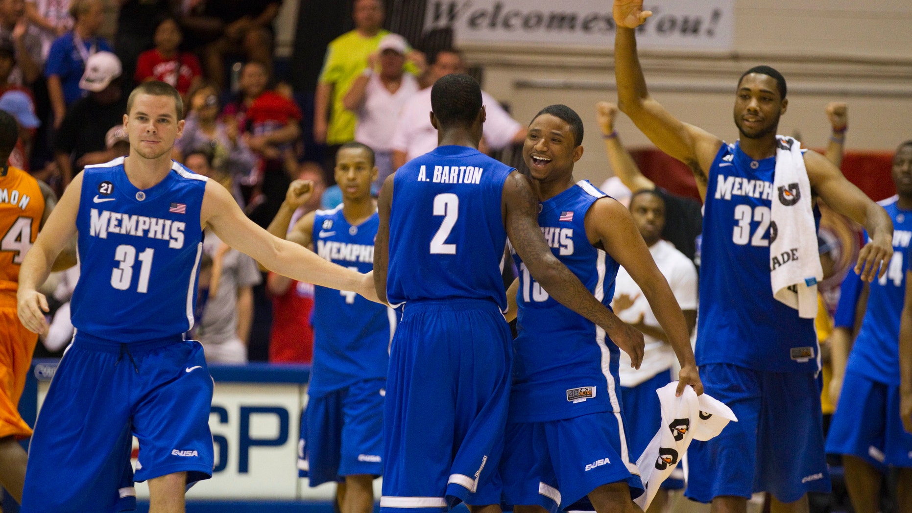 FILE - In this Nov. 22, 2011, file photo, Memphis' Preston Laird (31), Antonio Barton (2), Trey Draper, right center, and Stan Simpson (32) celebrate their double overtime win in a NCAA college basketball game against Tennessee, in Lahaina, Hawaii.