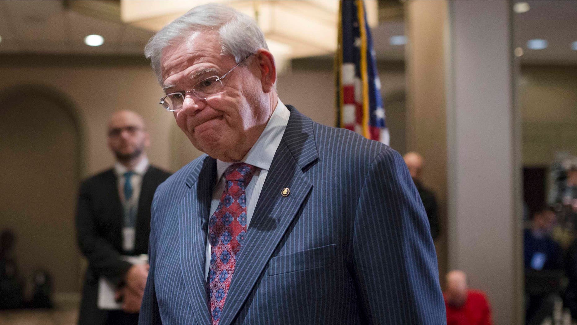 Sen. Bob Menendez, D-N.J., leaves after news conference in Newark, N.J. on Friday, March 6, 2015.