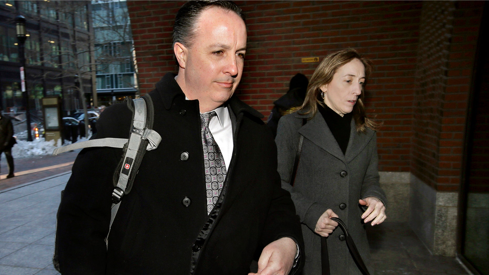 Barry Cadden, center, arrives at the federal courthouse, Thursday, March 16, 2017, in Boston, before scheduled closing arguments in his trial. Cadden, a former pharmacy executive and the president of New England Compounding Center, is charged with causing the deaths in 2012 of 25 people who received tainted steroids manufactured by the pharmacy. (AP Photo/Steven Senne)
