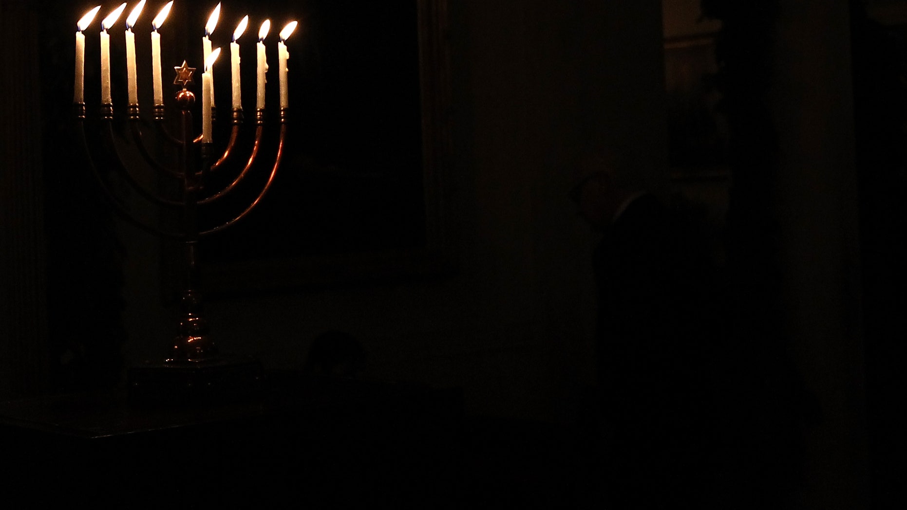WASHINGTON, DC - DECEMBER 08: (AFP OUT) A menorah burns in the White House after U.S. President Barack Obama delivered remarks during a Hanukkah reception December 8, 2011 in Washington, DC. The reception helped recognize and celebrate the Jewish tradition also known as the Festival of Lights. (Photo by Win McNamee/Getty Images)