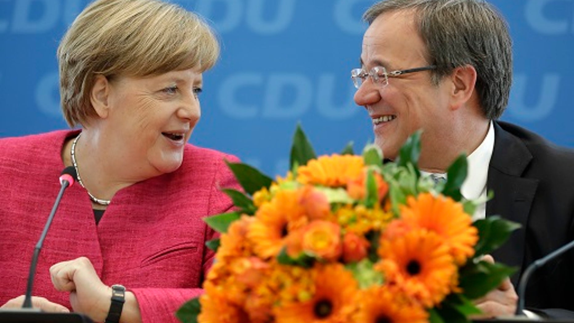 Angela Merkel, German Chancellor and chairwoman of the German Christian Democratic Party (CDU), is sitting with CDU top candidate for the state elections in North Rhine-Westphalia, Armin Laschet, in Berlin, Germany, on Monday, May 15, 2017.