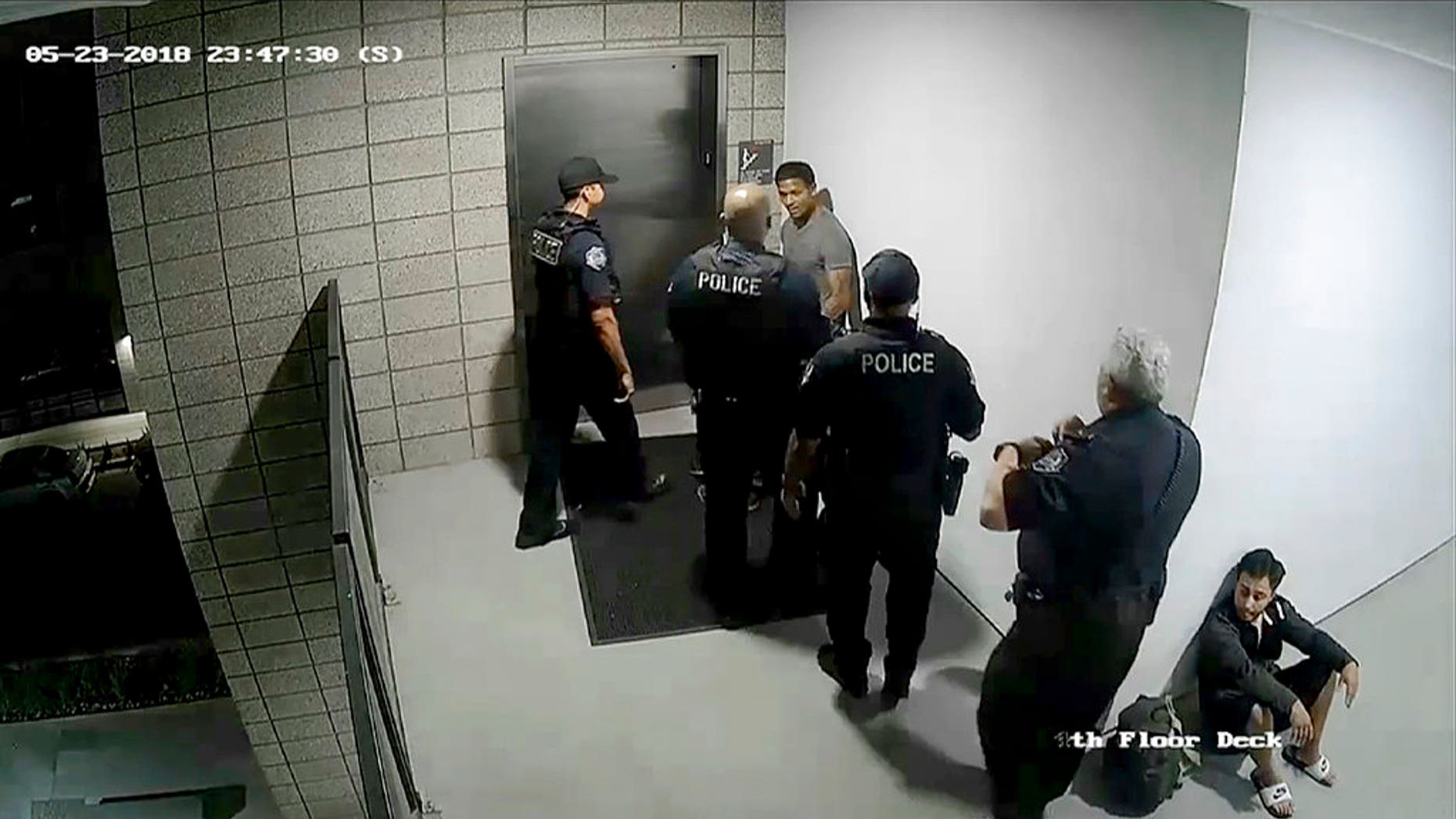 This image made from a surveillance video on Wednesday, May 23, 2018, released by the Mesa Police Department shows police officers approaching a man in Mesa, Ariz. A report from the incident states the man, Robert Johnson, was "verbally defiant and confrontational." Mesa police released the report, along with footage from police-worn cameras, on Wednesday, June 6, after video released by Johnson's attorneys circulated this week, raising criticism over the handling of the incident. (Mesa Police Department via AP)