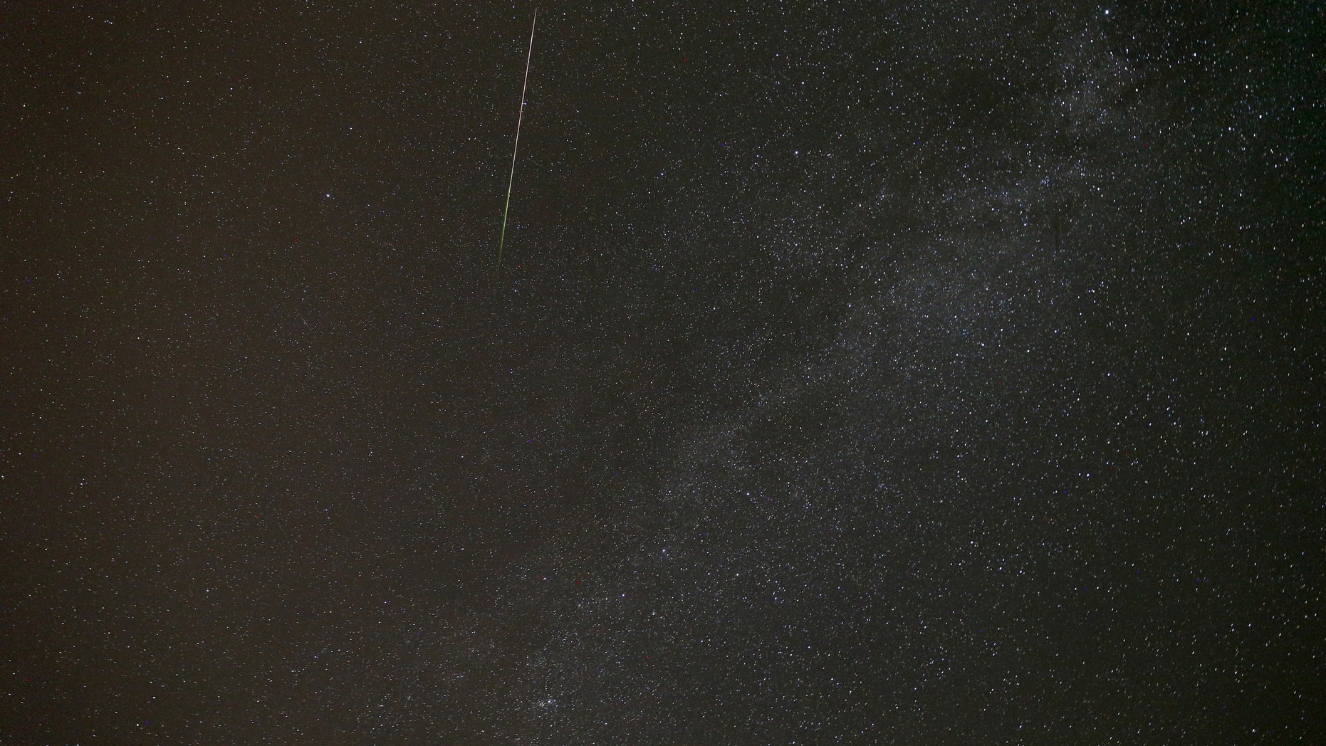 File photo - A meteor streaks across the sky during the Perseid meteor shower near the village of Malashki, north of Minsk, Belarus, in the early morning Aug. 13, 2015. (REUTERS/Vasily Fedosenko)