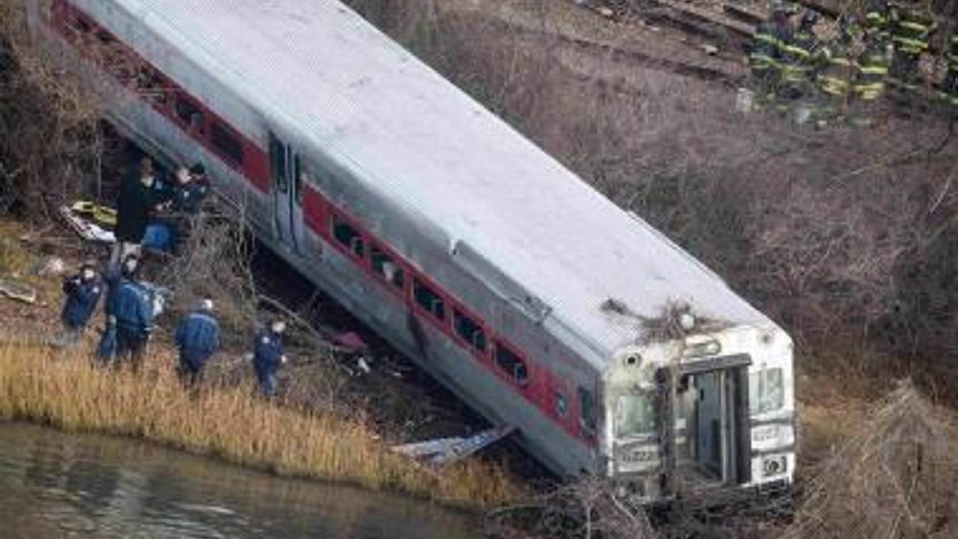 Emergency workers gather at the site of a Metro-North train derailment in the Bronx borough of New York, Dec. 1, 2013.