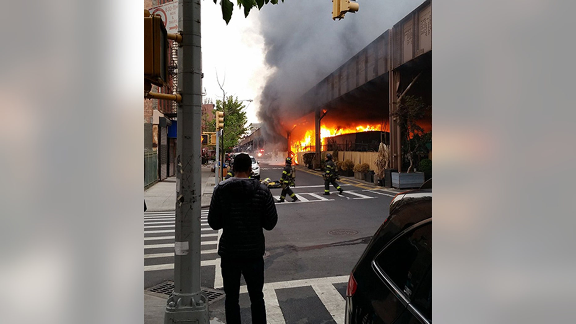 May 17, 2016: Firefighters battle a fire under the Metro-North railroad tracks in New York.