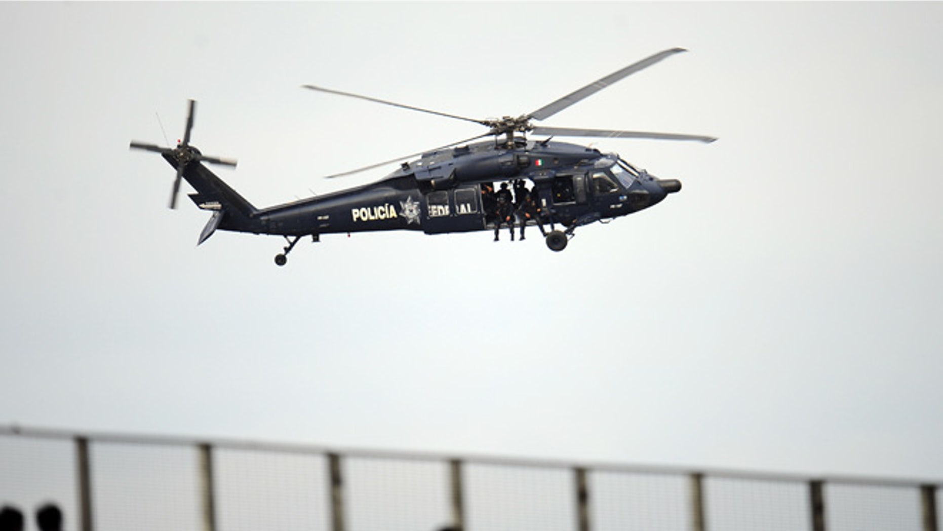 GUADALAJARA, MEXICO - OCTOBER 14: A federal police helicopter flies over before the Opening Ceremony for the XVI Pan American Games at Omnilife Stadium on October 14, 2011 in Guadalajara, Mexico. (Photo by Dennis Grombkowski/Getty Images)