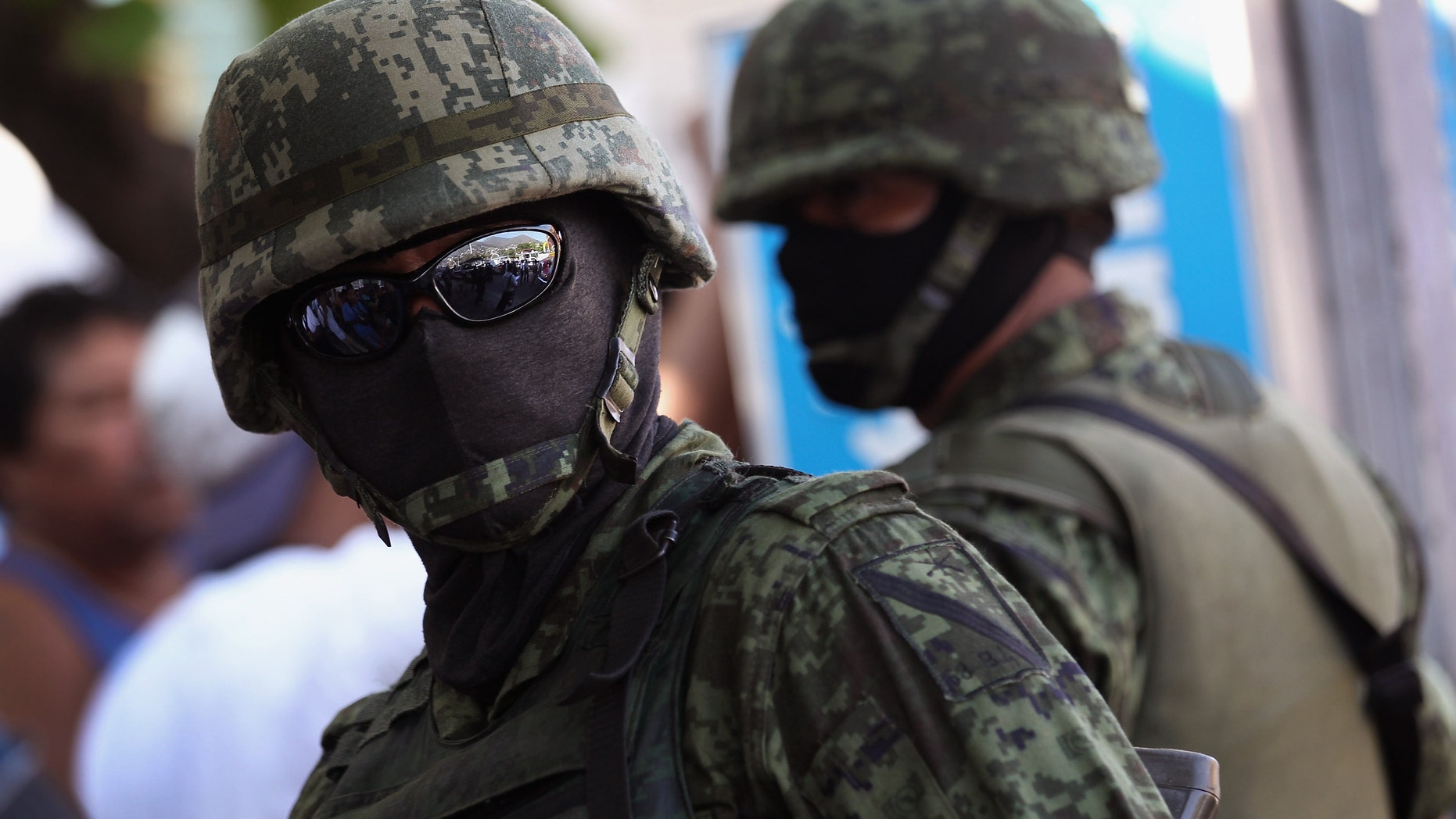ACAPULCO, MEXICO - FEBRUARY 29: Mexican army soldiers stand guard at the site of a suspected drug execution on February 29, 2012 in Acapulco, Mexico. Drug violence surged in the coastal resort last year, making Acapulco the second most deadly city in Mexico after Juarez. One of the country's top tourist destinations, Acapulco has suffered a drop in business, especially from foreign tourists. Toursim accounts for some 9 percent of Mexico's economy and about 70 percent of the output of Acapulco's state of Guerrero. (Photo by John Moore/Getty Images)