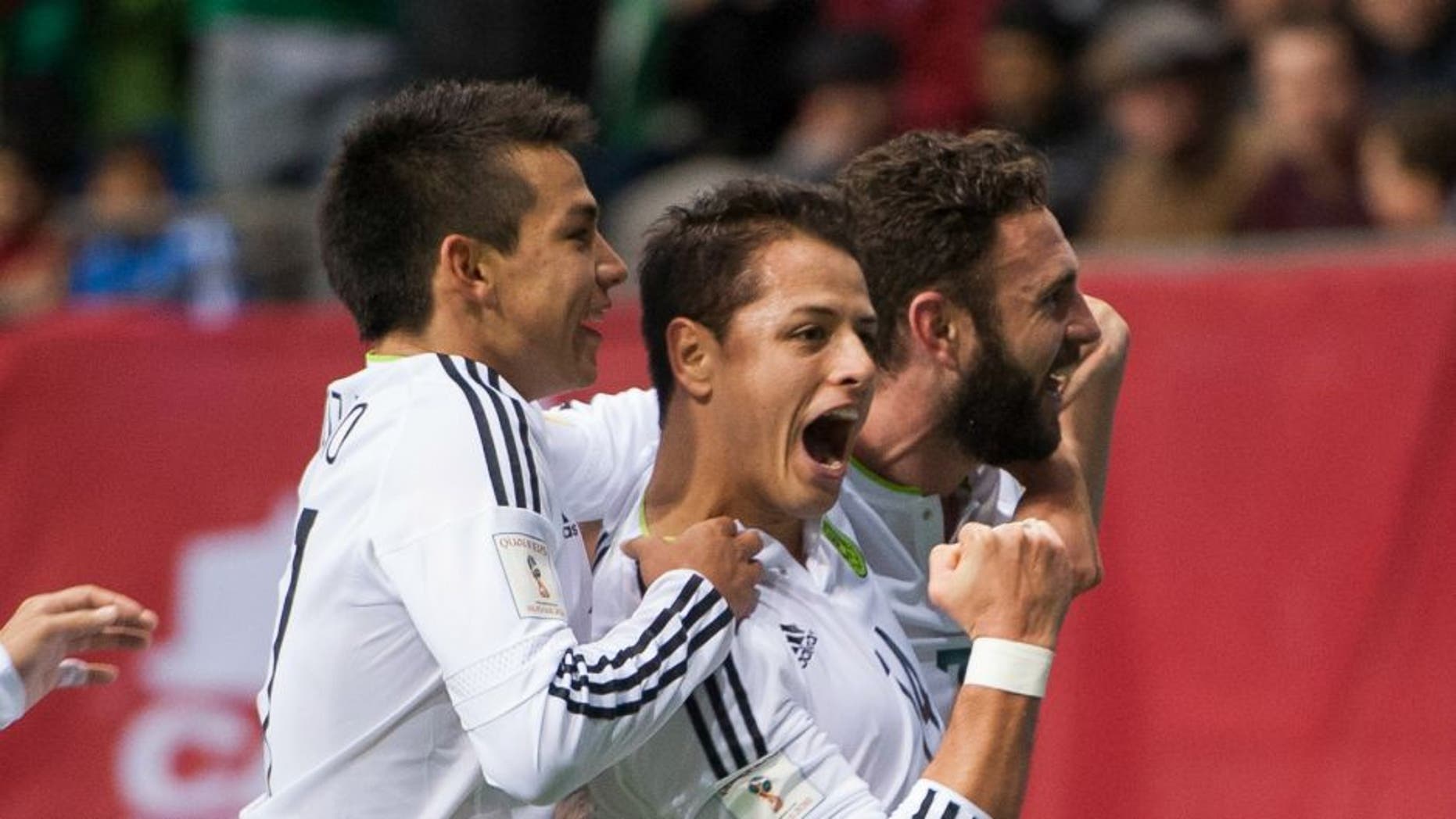 VANCOUVER, BC - MARCH 25: Javier "Chicharito" Herhandez #14 of Mexico is congratulated by teammates Javier Aquino #11 and Miguel Layun #7 of Mexico after scoring a goal against Canda during FIFA 2018 World Cup Qualifier soccer action at BC Place on March 25, 2016 in Vancouver, Canada. (Photo by Rich Lam/Getty Images)