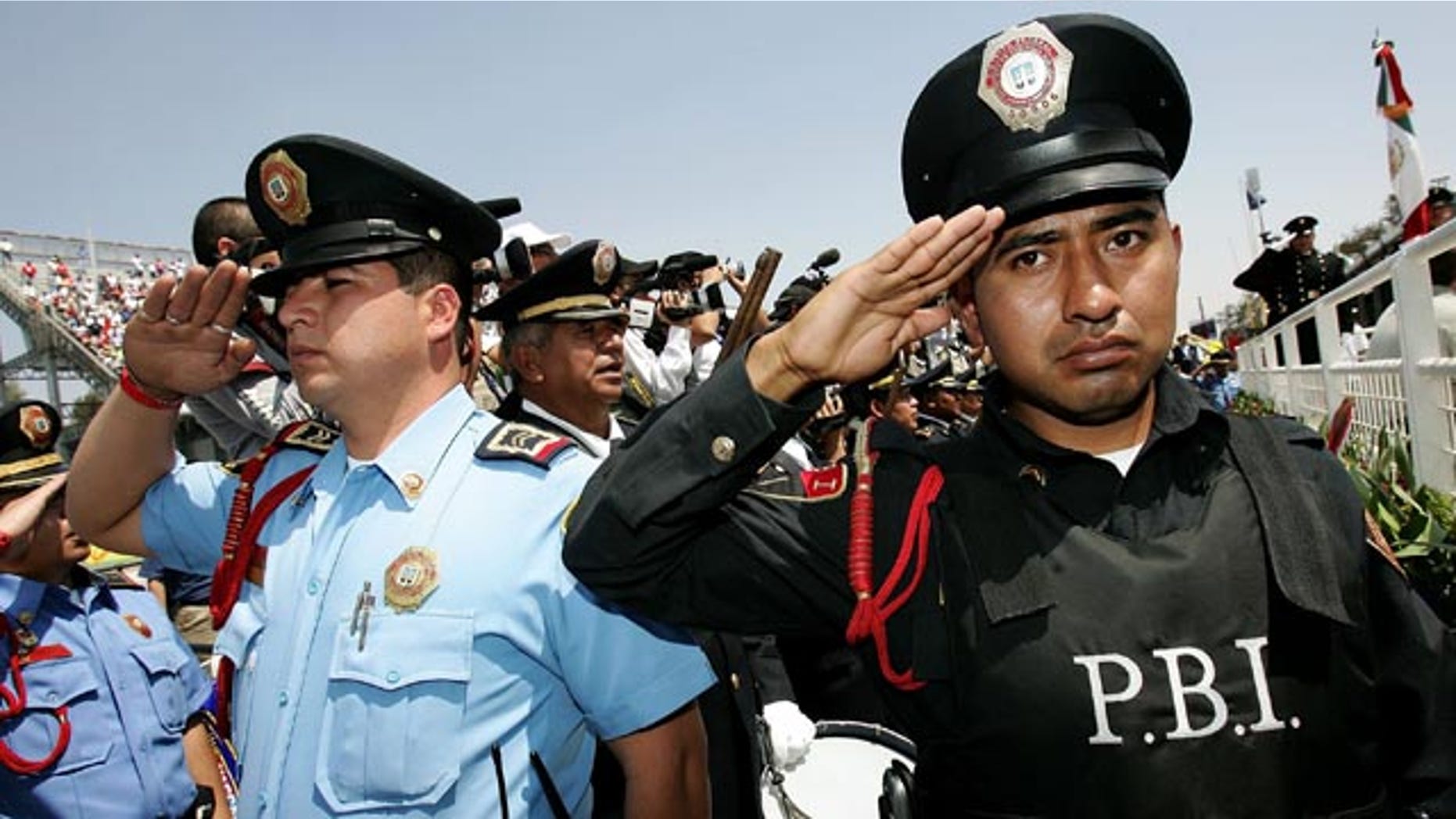MEXICO CITY - MARCH 05: Police members salute during the Mexican National Anthem during the NASCAR Busch Series Telcel-Motorola 200 on March 5. 2006 at Autodromo Hermanos Rodriguez in Mexico City, Mexico. (Photo by Jonathan Ferrey/Getty Images)