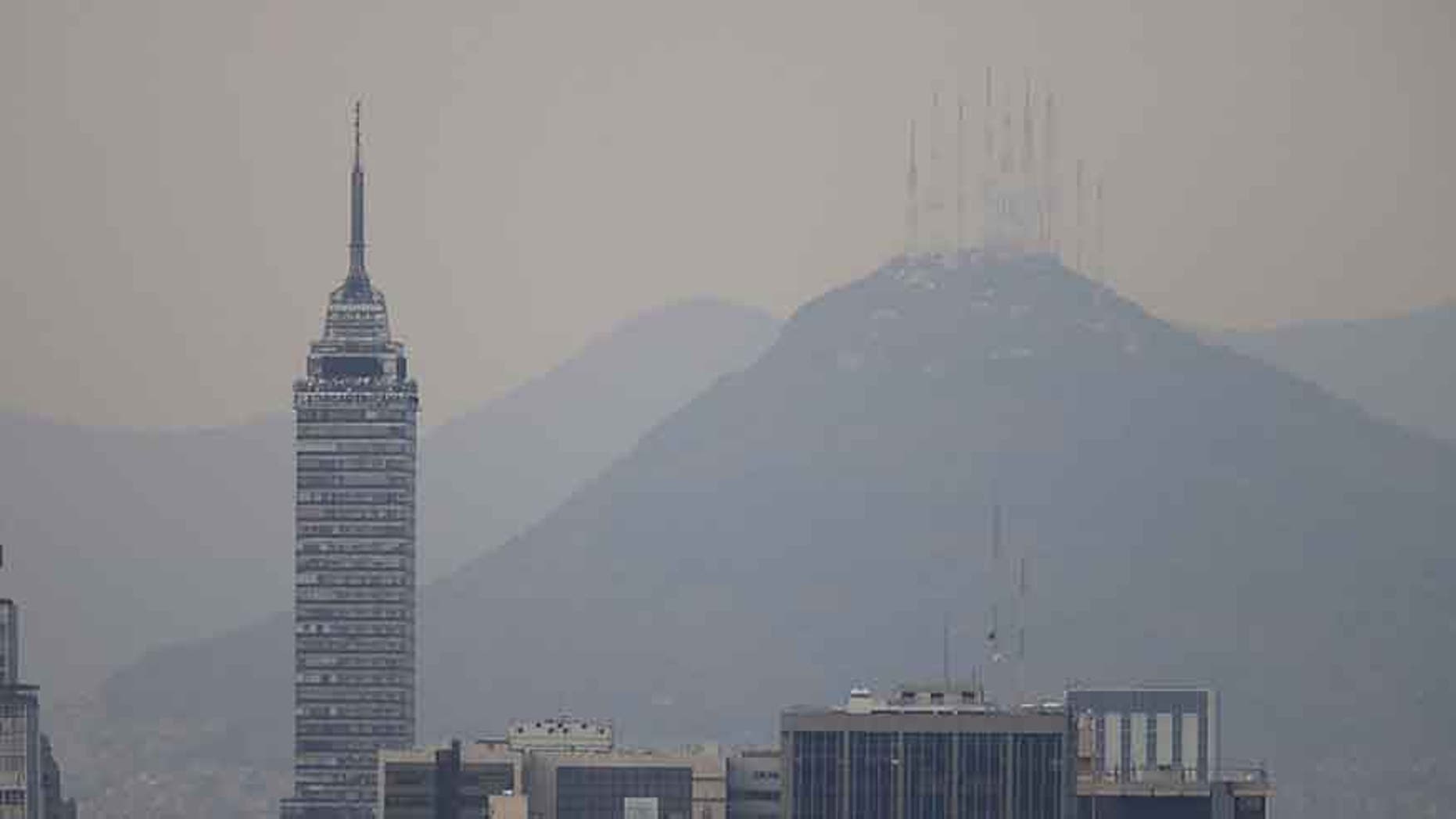 Buildings stand shrouded in smog in Mexico City, March 14, 2016.