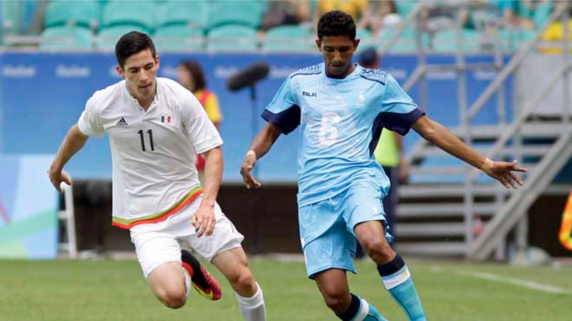 Mexico's Marco Bueno, left, fights for the ball with Fiji's Anish Khem during a group C match of the men's Olympic football tournament between Mexico and Fiji at the Fonte Nova Arena in Salvador, Brazil, Sunday, Aug. 7, 2016. (AP Photo/Arisson Marinho)