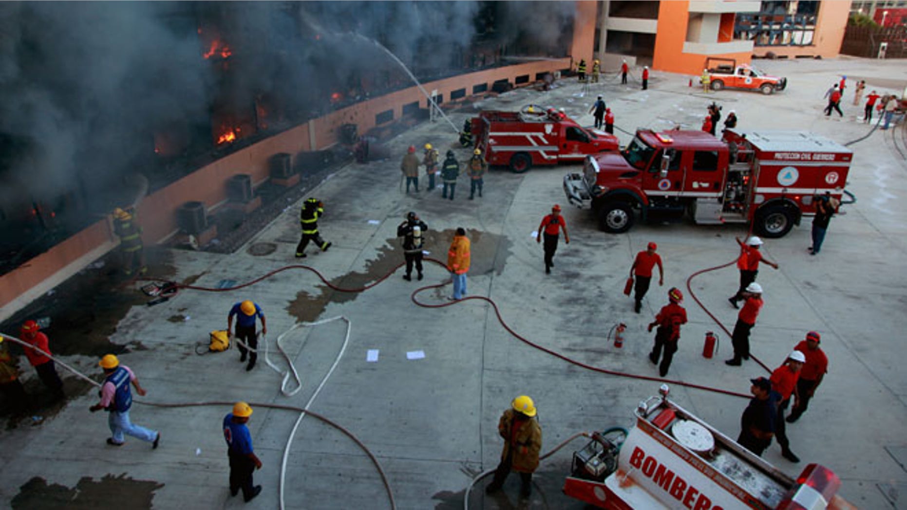 Oct. 13, 2014: Firefighters try to extinguish the flames after the state capital building was set on fire by protesting college students in Chilpancingo, Mexico