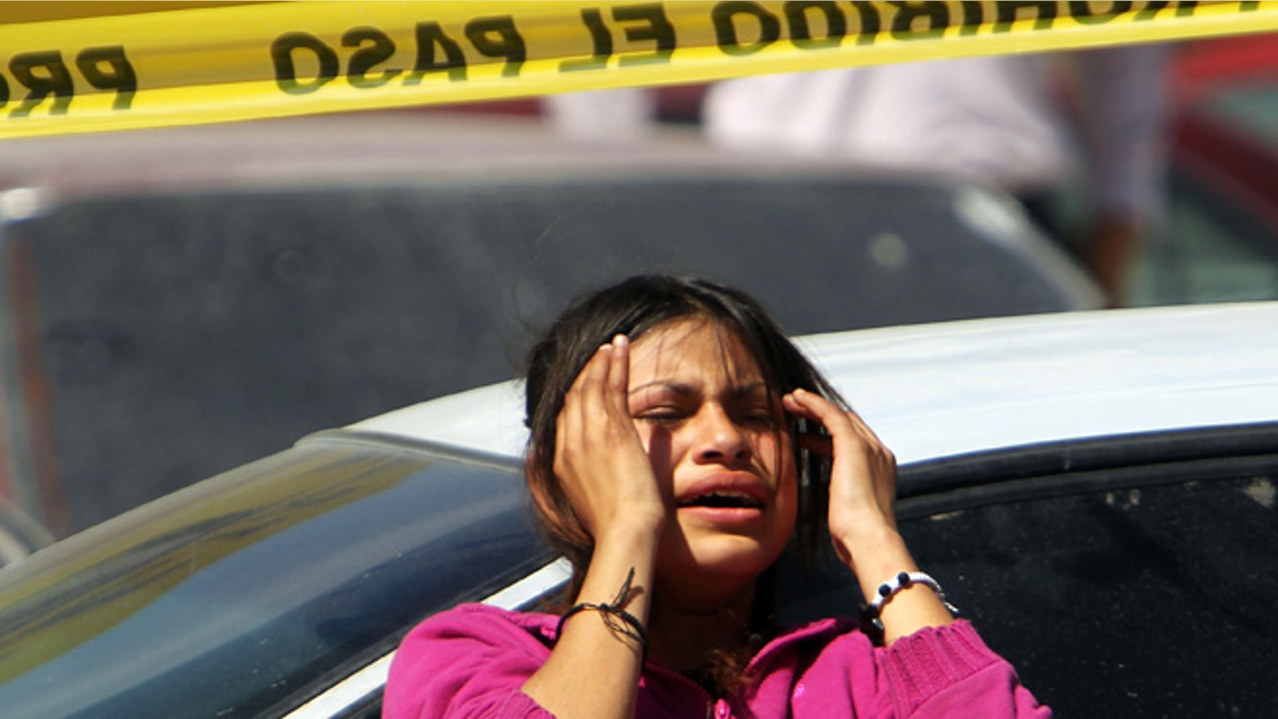 JUAREZ, MEXICO - MARCH 22: Family members grieve in front of a car in which two men lay dead on March 22, 2010 in Juarez, Mexico. Both men, who were 18 and 34 years of age, were shot by a group of teenagers. The border city of Juarez, Mexico has been racked by violent drug related crime recently and has quickly become one of the most dangerous cities in the world to live. As drug cartels have been fighting over ever lucrative drug corridors along the United States border, the murder rate in Juarez has risen to 173 slayings for every 100,000 residents. President Felipe Calderon?s strategy of sending 7000 troops to Juarez has not mitigated the situation. With a population of 1.3 million, 2,600 people died in drug-related violence last year and 500 so far this year, including two Americans recently who worked for the U.S. Consulate and were killed as they returned from a children?s party. (Photo by Spencer Platt/Getty Images)