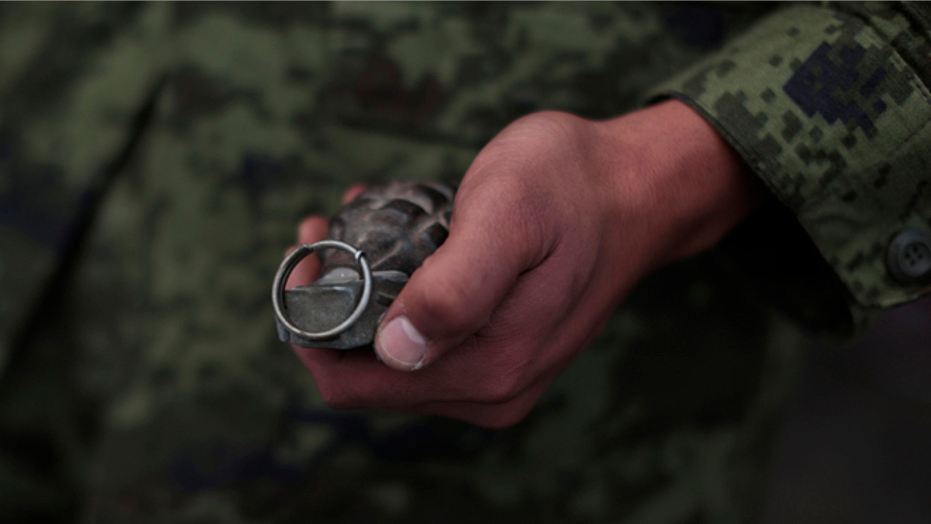 In this file photo, a soldier holds a grenade in Mexico City, Mexico.