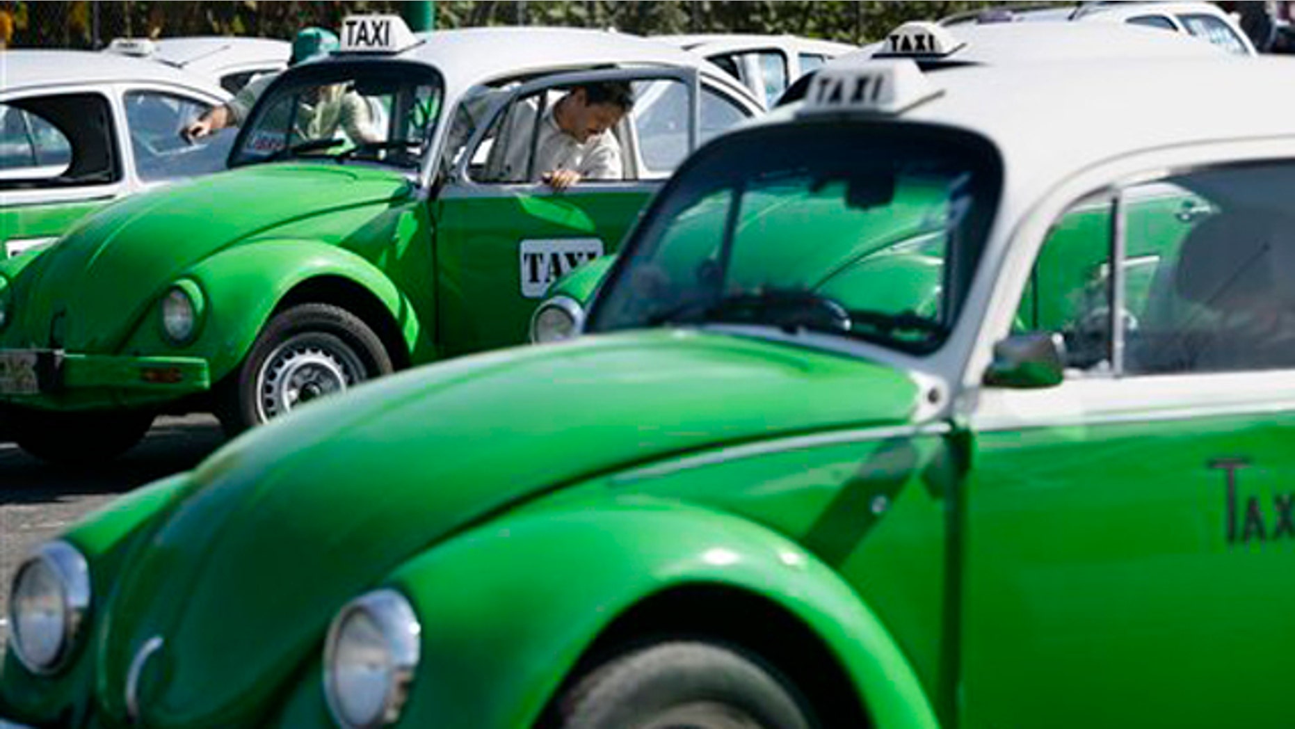 Dec. 28, 2007: In this photo, a man steps out of his Volkswagen beetle taxi during an inspection in Mexico City. Mexico City has announced that the last of the iconic Volkswagen Beetle taxis will be withdrawn from service by the end of 2012.