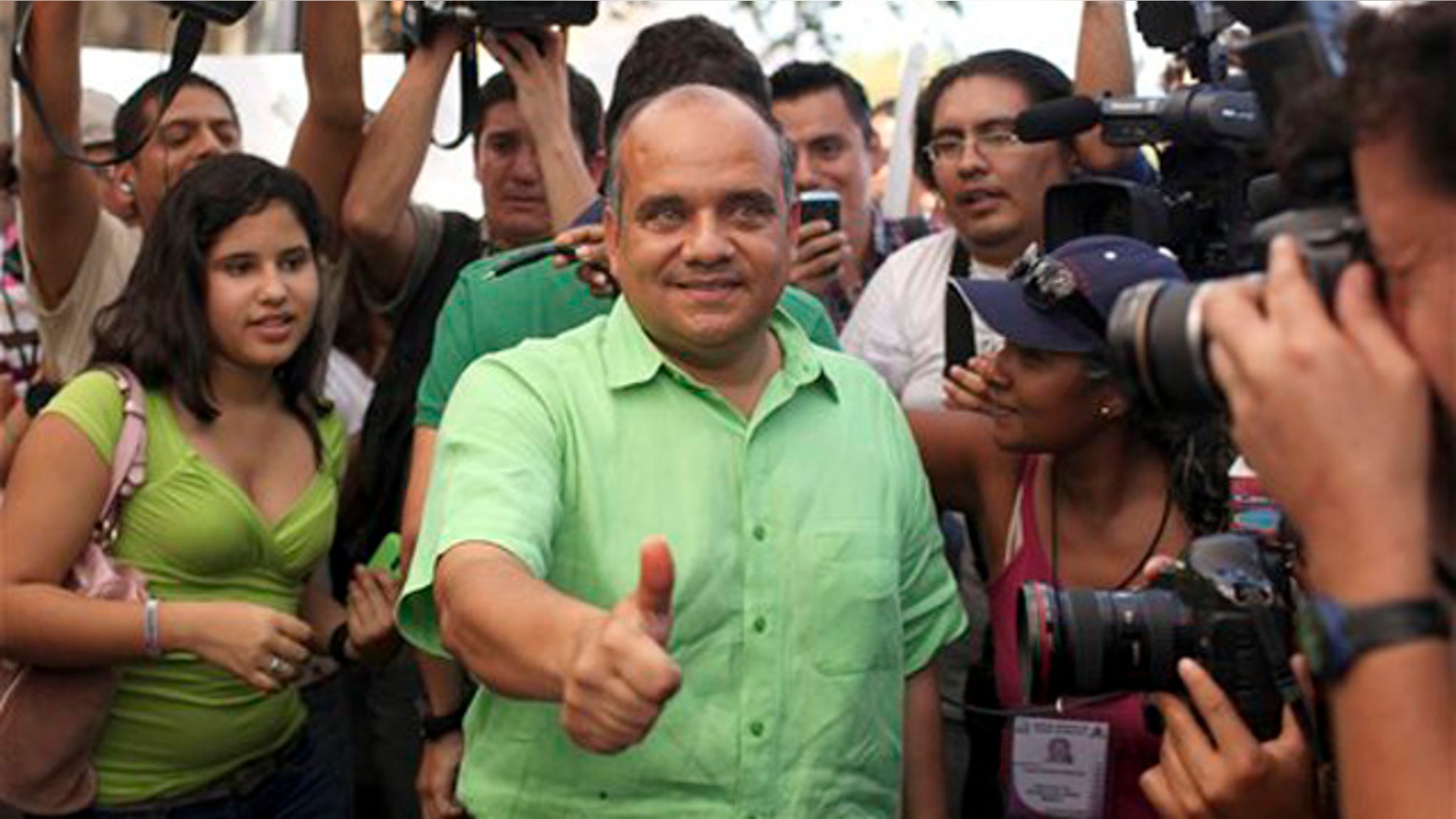 Jan. 30, 2011: Candidate for state governor Manuel Anorve, of the Institutional Revolutionary Party, PRI, center, gestures as he poses for photos after casting his vote in Acapulco, Mexico. Corruption scandals, political violence and the drug war shadow Sunday's gubernatorial election in the Pacific coast state of Guerrero, home to the resort city of Acapulco and a cartel battleground.