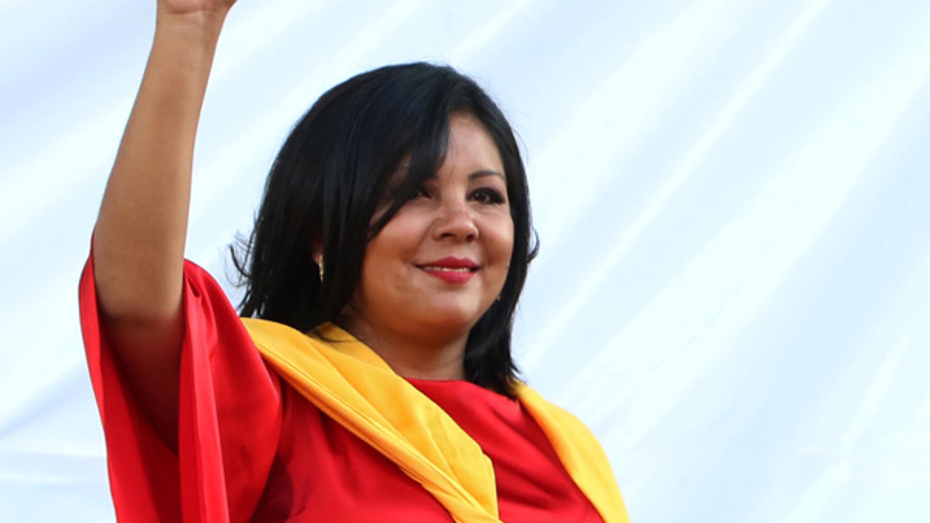 In this Friday, Jan. 1, 2016 photo, Gisela Mota waves during her swearing in ceremony as mayor of Temixco, Morelos State, Mexico. The Morelos state Public Security Commission says attackers invaded Mota's house on Saturday morning and killed her. (AP Photo/Tony Rivera)