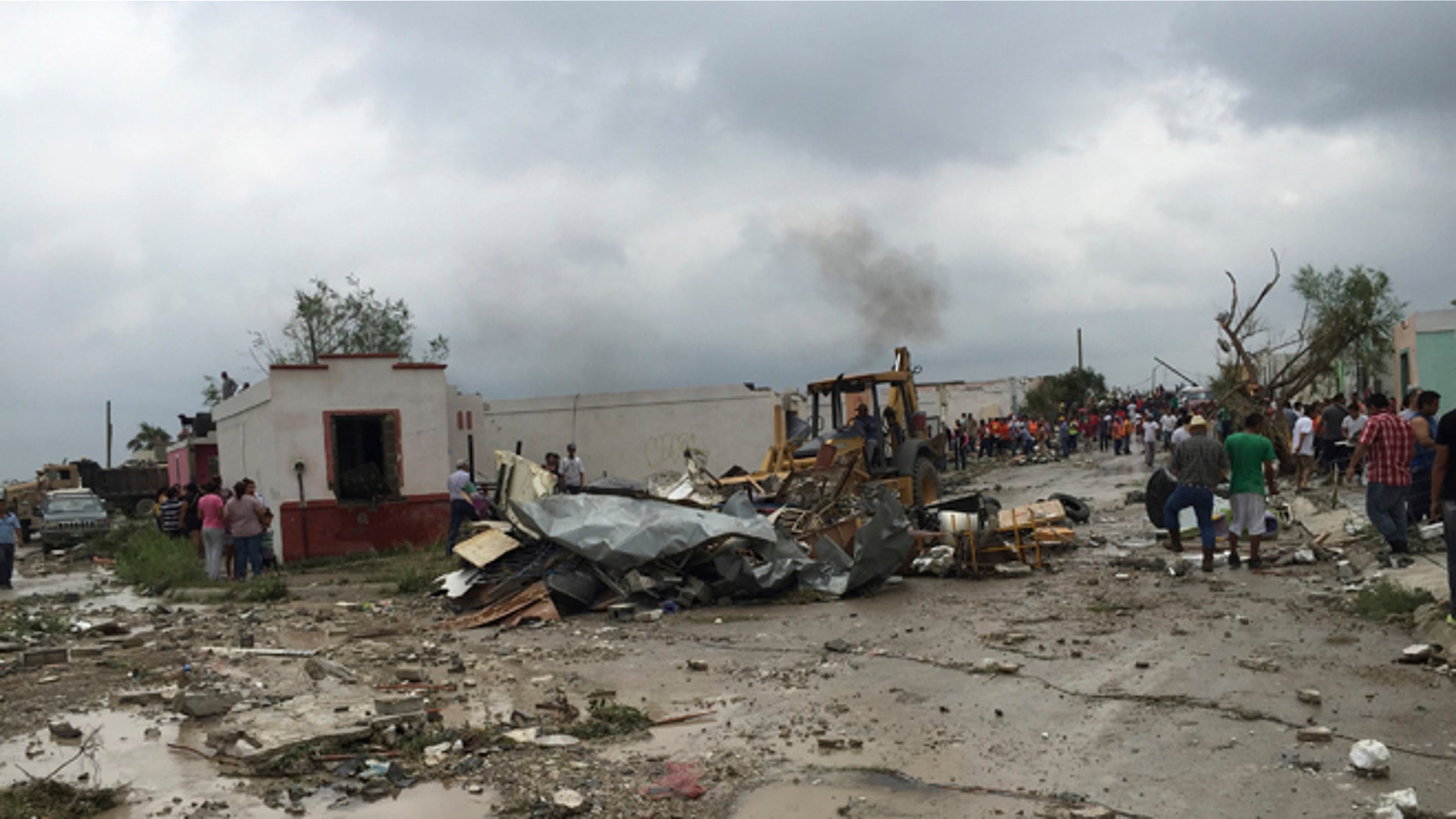 May 25, 2015: A bulldozer clears away debris after a powerful tornado swept past in Ciudad Acuna, northern Mexico.