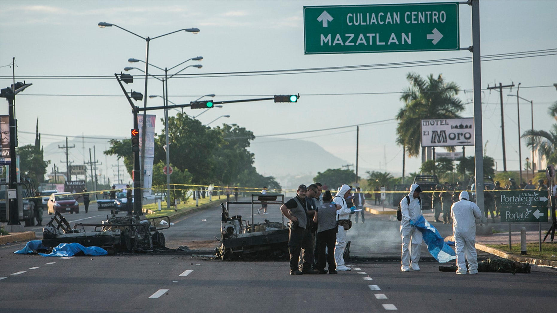 Sept. 30, 2016: Police investigators examine the site where a military convoy was ambushed using grenades and high-powered guns, killing five soldiers in the city of Culiacan, Mexico.