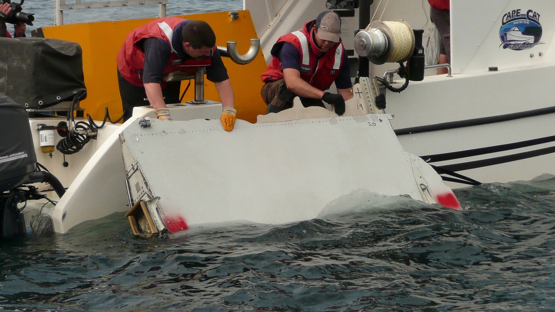 A Boeing 777 flaperon cut down to match the one from flight MH370 found on Reunion island off the coast of Africa in 2015, is lowered into water to discover its drift characteristics by Commonwealth Scientific and Industrial Research Organisation researchers in Tasmania, Australia, in this handout image taken March 23, 2017.