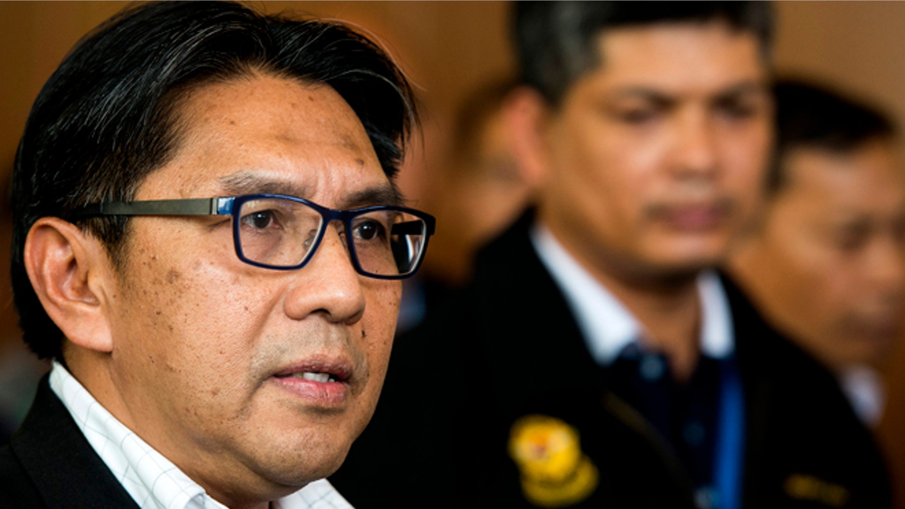 April 2, 2014: Malaysia's civil aviation chief Azharuddin Abdul Rahman, left, is accompanied by an unidentified Malaysia Airlines official while answering questions during a press conference after a close door meeting with Chinese relatives of the passengers onboard the missing Malaysia Airlines Flight 370 at a hotel in Bangi, on the outskirts of Kuala Lumpur, Malaysia.