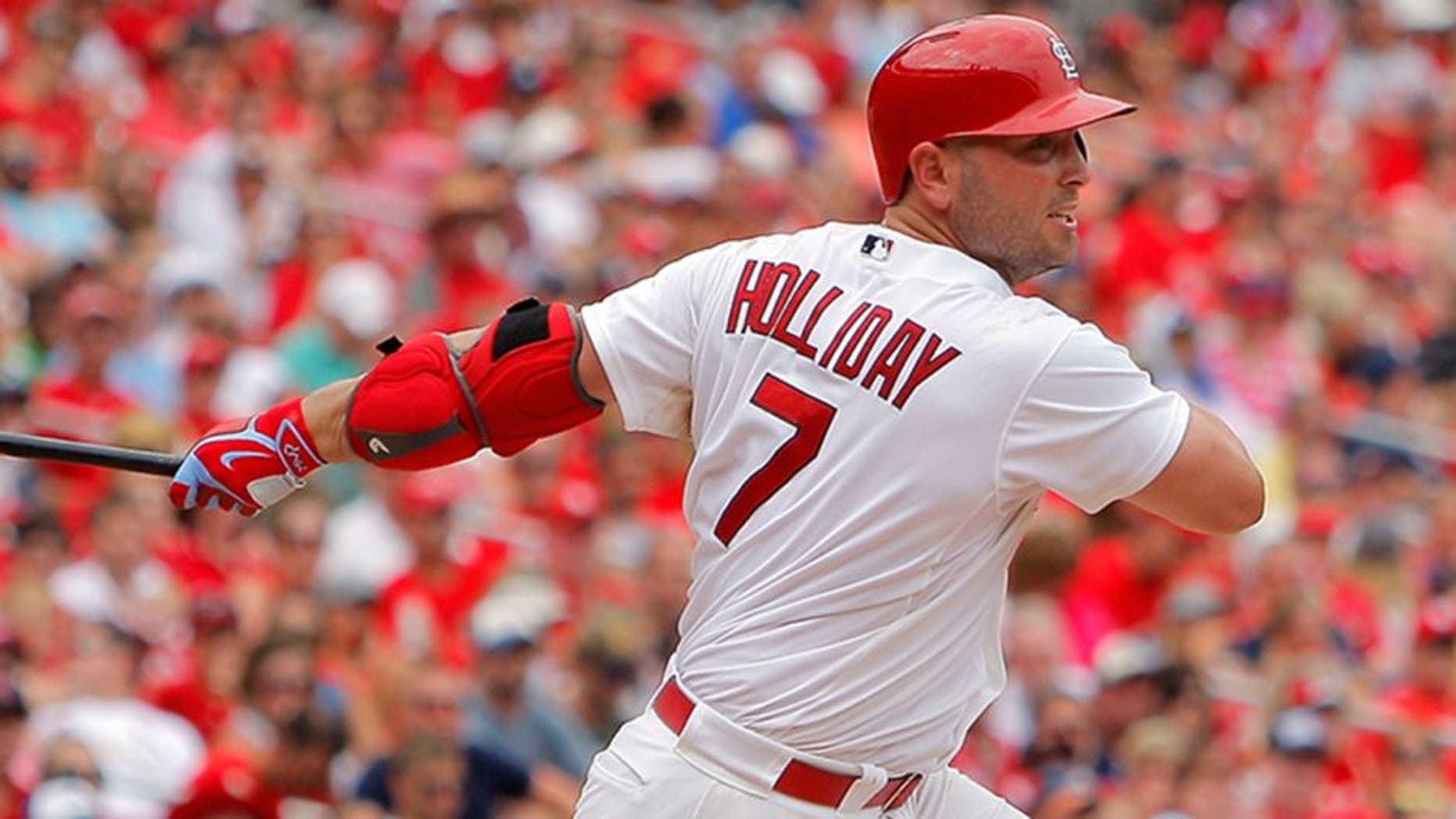 Jul 26, 2015; St. Louis, MO, USA; St. Louis Cardinals left fielder Matt Holliday (7) follows through on a RBI double during the fifth inning against the Atlanta Braves at Busch Stadium. The Braves won 3-2. Mandatory Credit: Scott Kane-USA TODAY Sports
