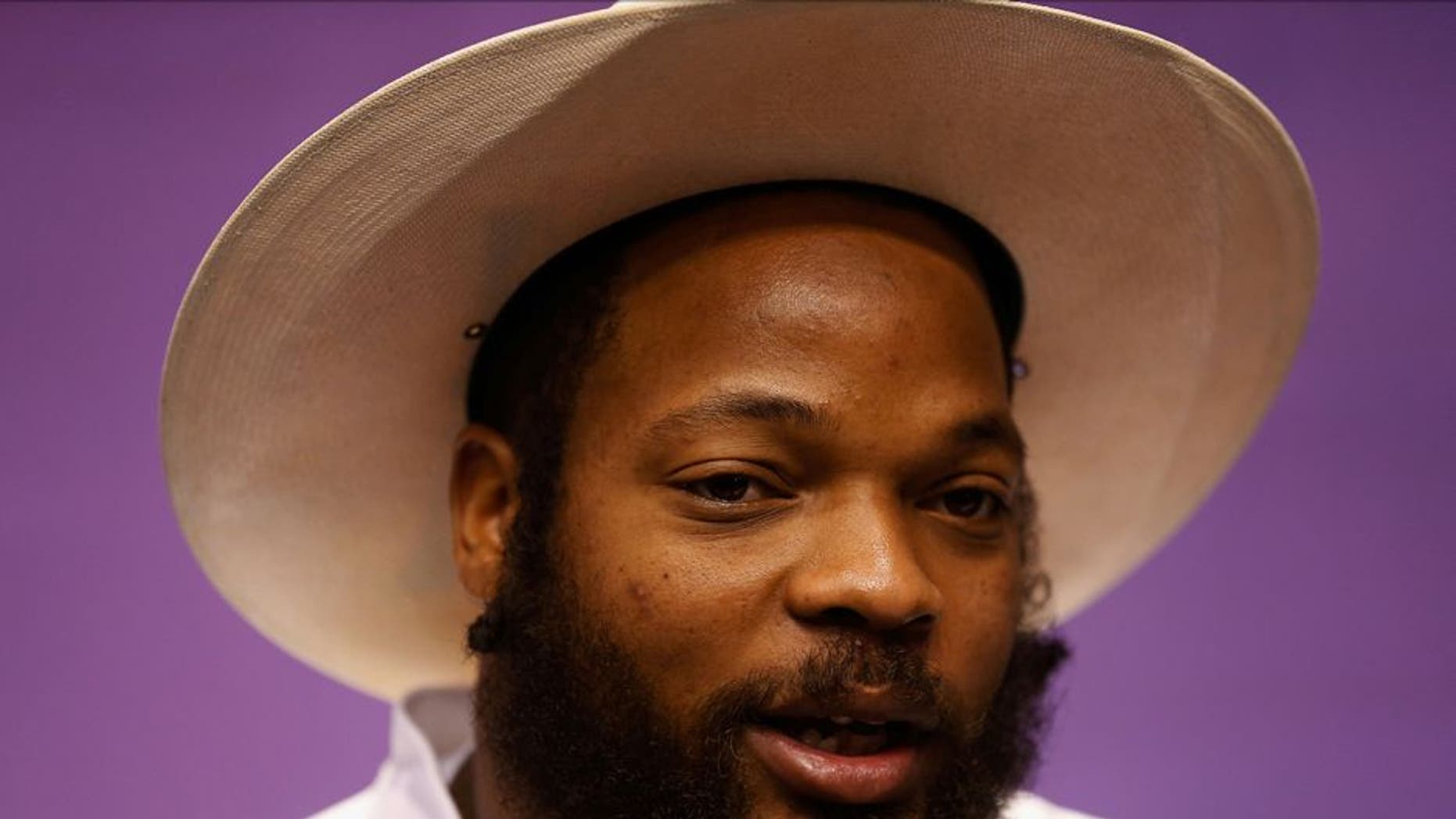 PHOENIX, AZ - JANUARY 27: Michael Bennett #72 of the Seattle Seahawks addresses the media at Super Bowl XLIX Media Day Fueled by Gatorade inside U.S. Airways Center on January 27, 2015 in Phoenix, Arizona. (Photo by Christian Petersen/Getty Images)