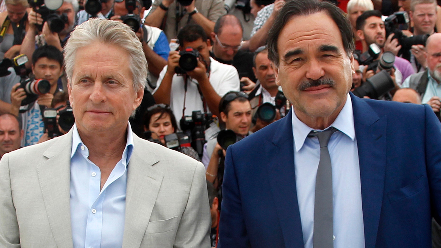 Michael Douglas, left, poses with director Oliver Stone during a photocall for "Wall Street - Money Never Sleeps."