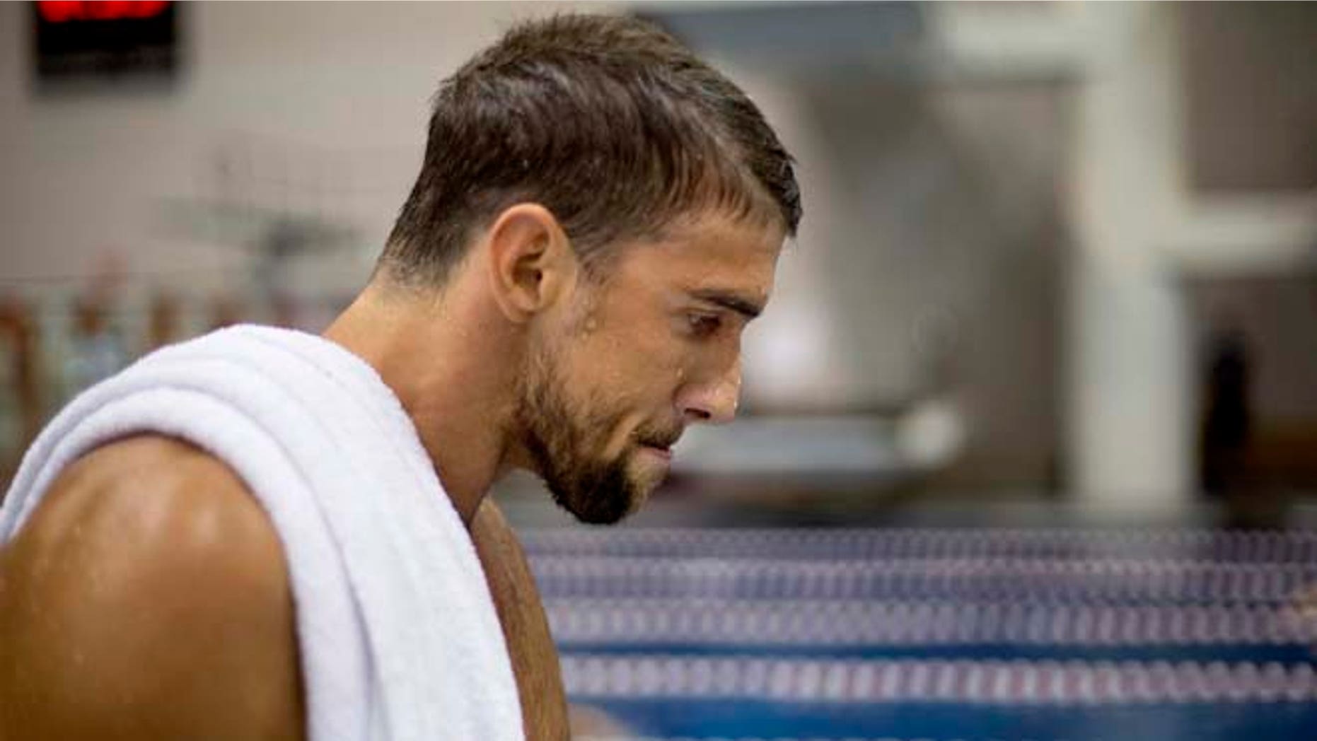 July 11, 2014: Michael Phelps walks away from the starting block after winning the men's 100-meter butterfly at the Bulldog Grand Slam swim meet at the University of Georgia in Athens, Ga.