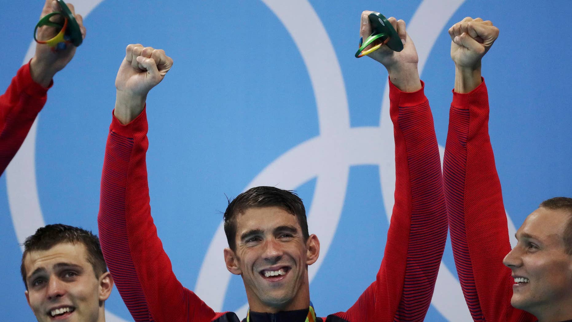Michael Phelps, Ryan Held and Caeleb Dressel of USA celebrate on the podium during the 2016 Rio Olympics.