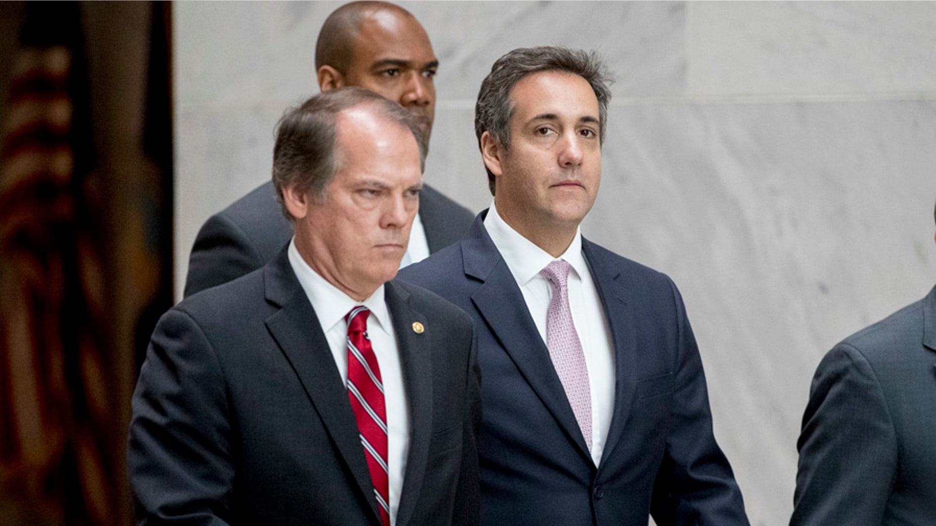 President Donald Trump's lawyer Michael Cohen, center, departs following a closed door meeting with the Senate Intelligence Committee on Capitol Hill, Tuesday, Sept. 19, 2017, in Washington. (AP Photo/Andrew Harnik)