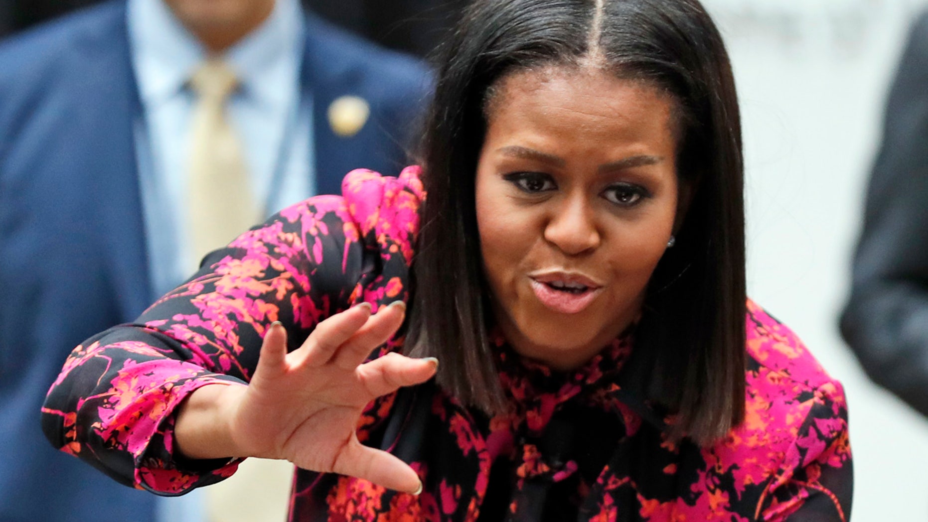FILE - In this Dec. 12, 2016, file photo, first lady Michelle Obama waves as she departs after a holiday event at Children's National Health System in Washington.
