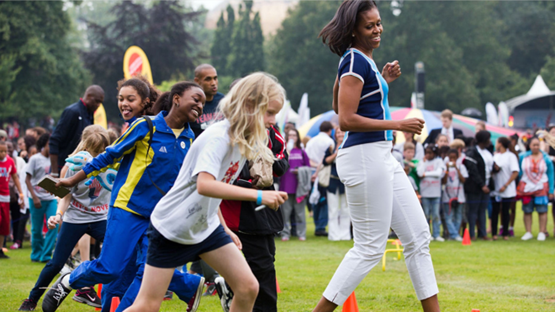 First lady Michelle Obama runs at an activity station during a ìLetÃs Move! London event at Winfield House in London.