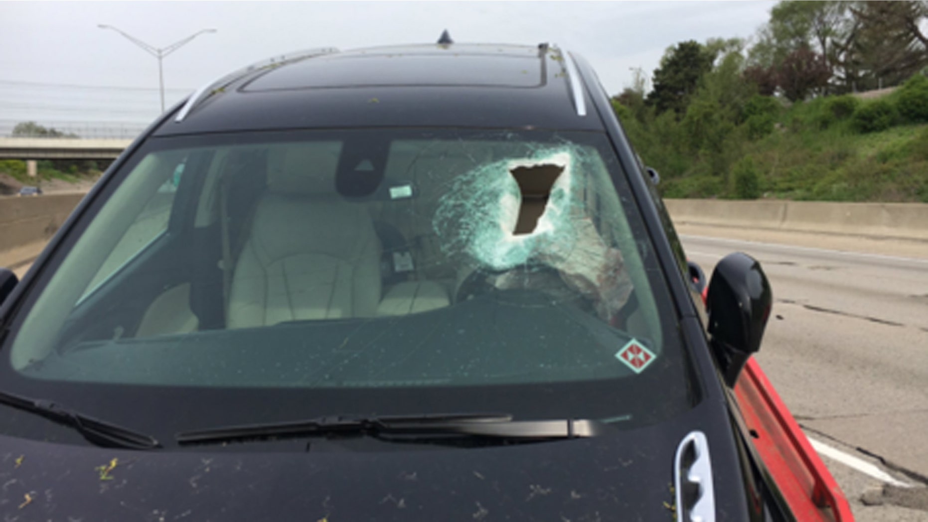 A woman was knocked unconscious Wednesday when a piece of concrete came off I-696 and crashed through her windshield.