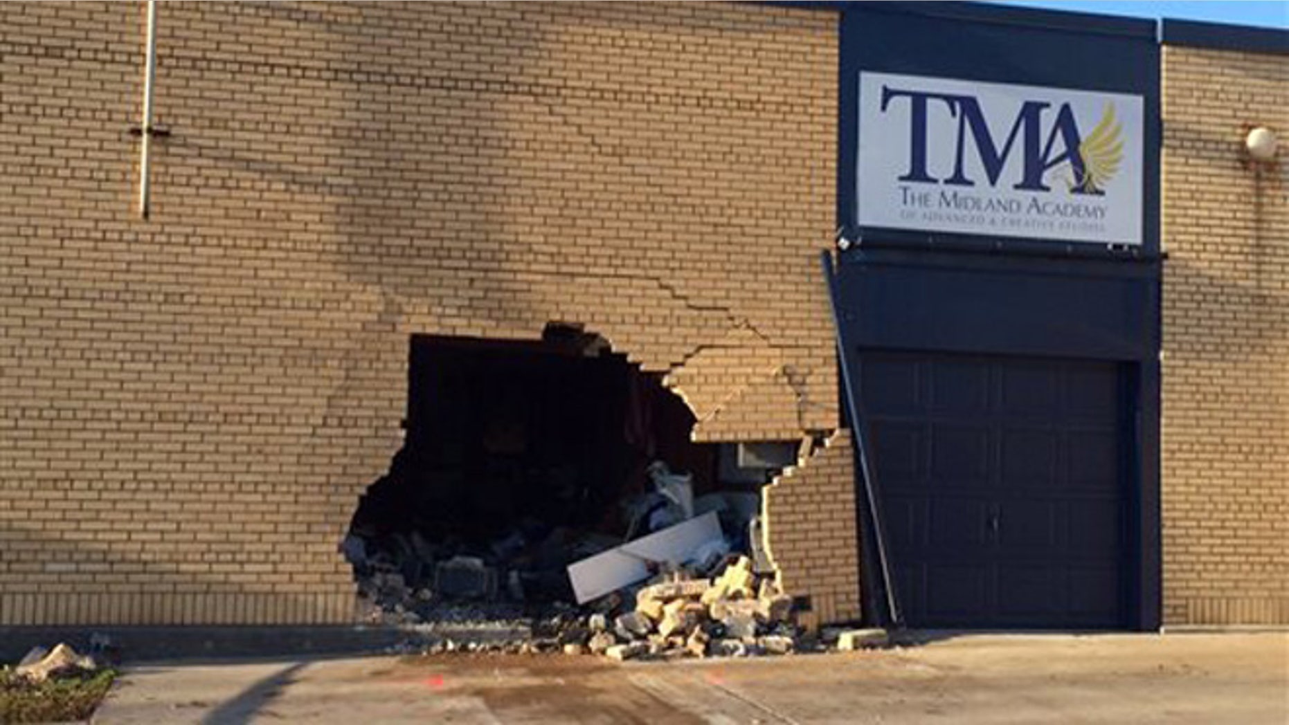 Nov. 3, 2015: This photo shows the scene where police say a vehicle crashed through the wall of Midland Academy, a school that was closed for the night, killing two passengers and injuring the driver.