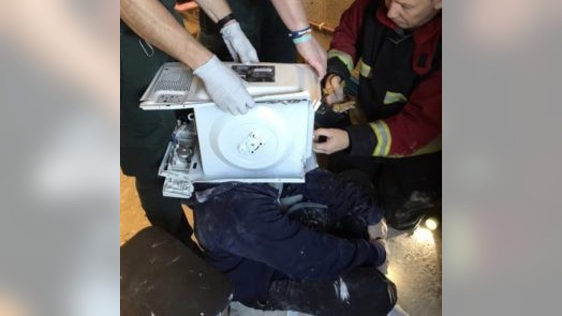 Firefighters were called to rescue a man who had cemented a microwave oven on his head in a YouTube stunt. (© West Midlands Fire Service)