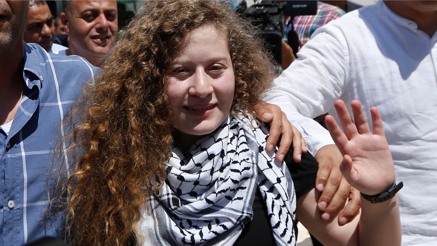 Ahed Tamimi waves after she visited the tomb of former Palestinian leader Yasser Arafat in the West Bank city of Ramallah.