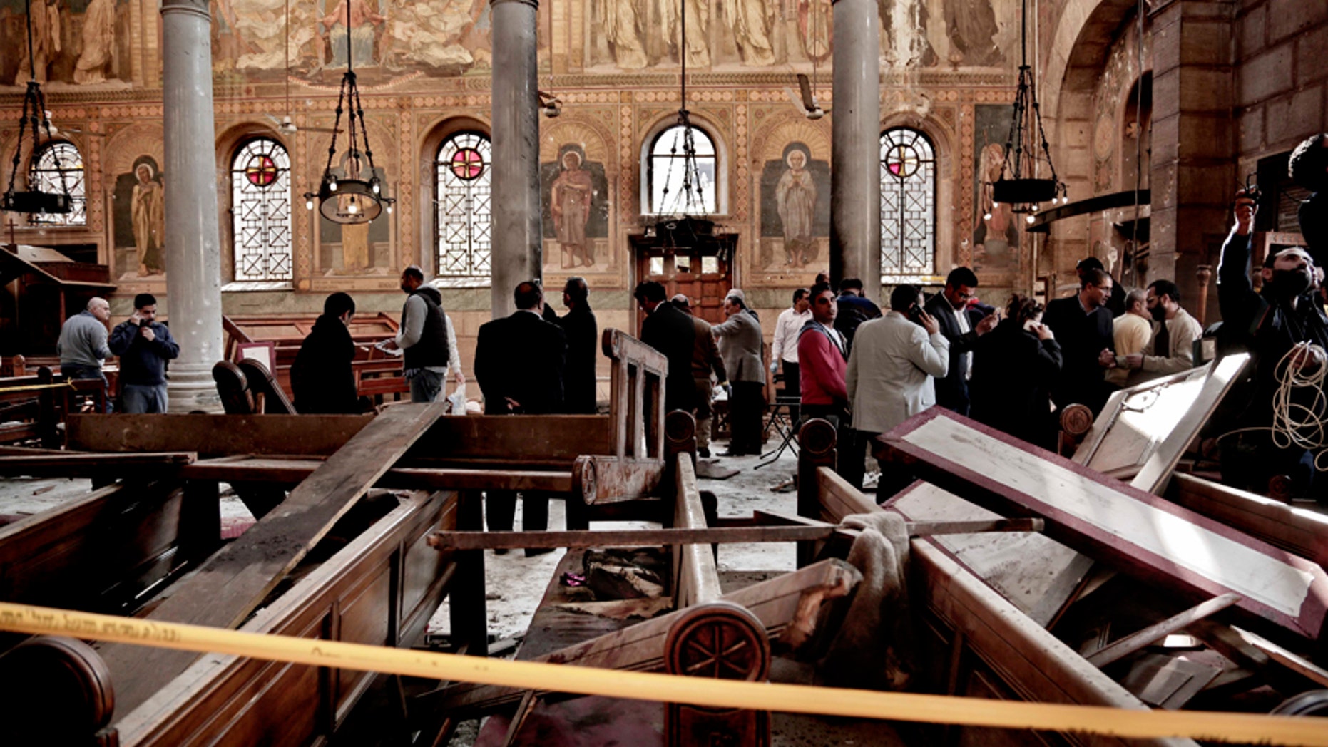 Security forces examine the scene inside the St. Mark Cathedral in central Cairo, following a bombing, Sunday, Dec. 11, 2016. The blast at Egypt's main Coptic Christian cathedral killed dozens of people and wounded many others on Sunday, according to Egyptian state television, making it one of the deadliest attacks carried out against the religious minority in recent memory. (AP Photo/Nariman El-Mofty)
