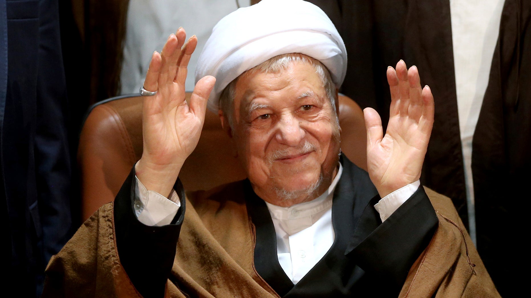 FILE -- Former Iranian President Akbar Hashemi Rafsanjani waves to journalists as he registers his candidacy for the elections of the Experts Assembly, in Tehran, Iran.