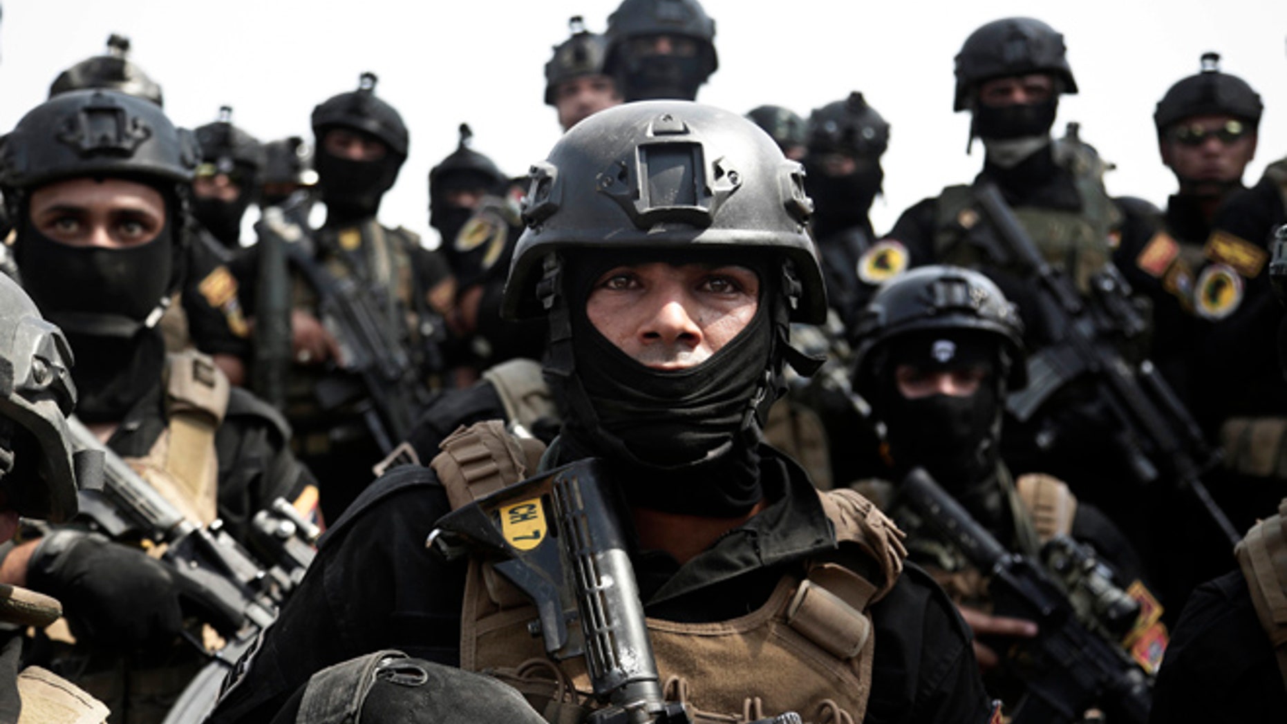 In this Saturday, Aug. 13, 2016 photo, a soldier from the 1st Battalion of the Iraqi Special Operations Forces listens to an address by his commander after a training exercise to prepare for the operation to re-take Mosul from Islamic State militants, in Baghdad, Iraq.