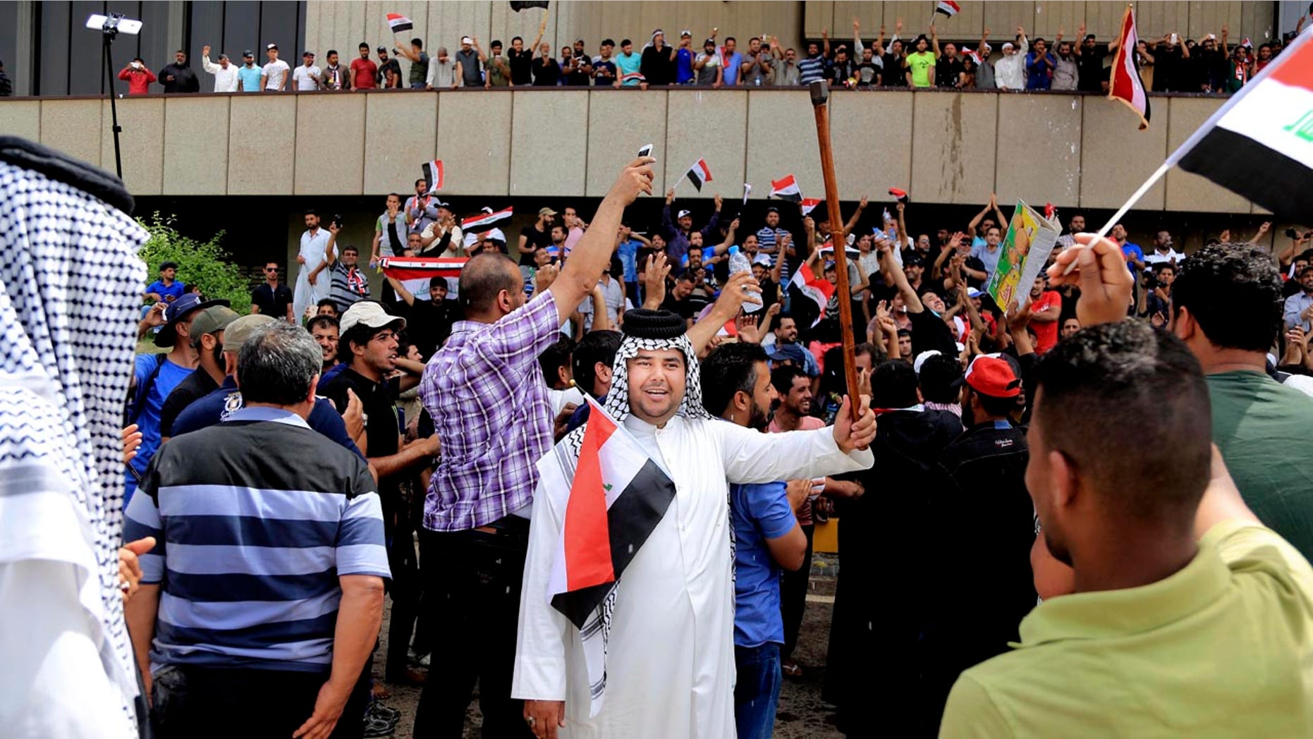 Supporters of Shiite cleric Muqtada al-Sadr chant slogans calling for governmental reforms as they wave national flags before ending their sit-in inside Baghdad's highly fortified Green Zone Sunday.