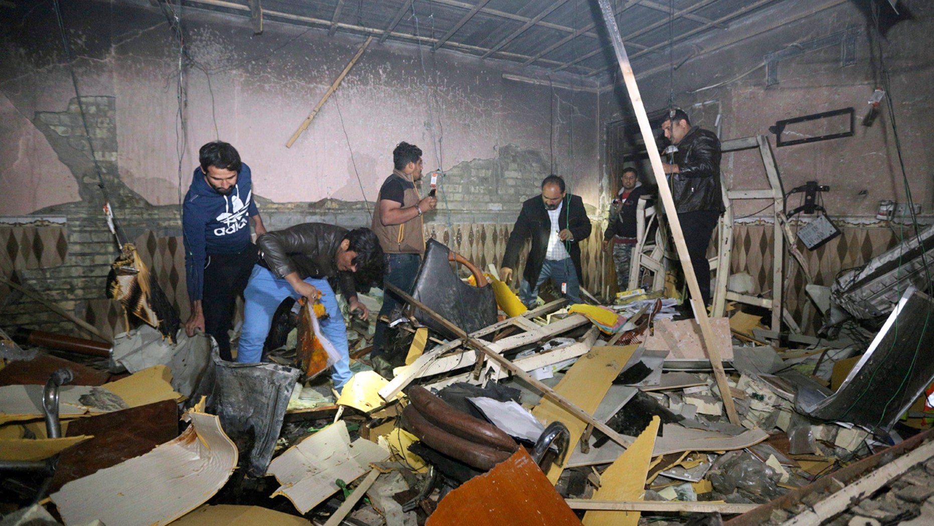 Civilians search for survivors in the rubble at the scene of a car bomb attack near the city of Hilla about 95 kilometers (60 miles) south of Baghdad, Iraq, Thursday, Nov. 24, 2016.