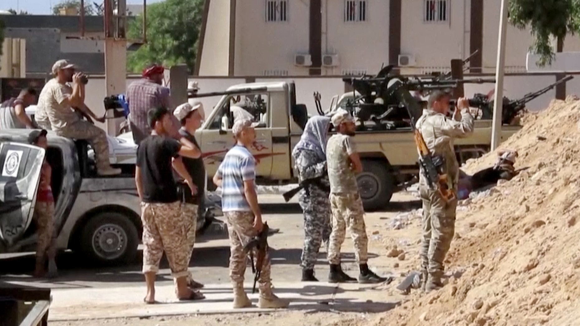 FILE -- June 14, 2016: This image made from Associated Press video shows Armed Misrata fighters loyal to the unity government on the main street of Sirte. A Libyan hospital spokesman says many pro-government fighters have been killed and tens wounded in latest fighting for the Islamic State group's bastion of Sirte. Libyan forces loyal to the unity government have been waging an offensive since last month to dislodge the militants from the coastal city.