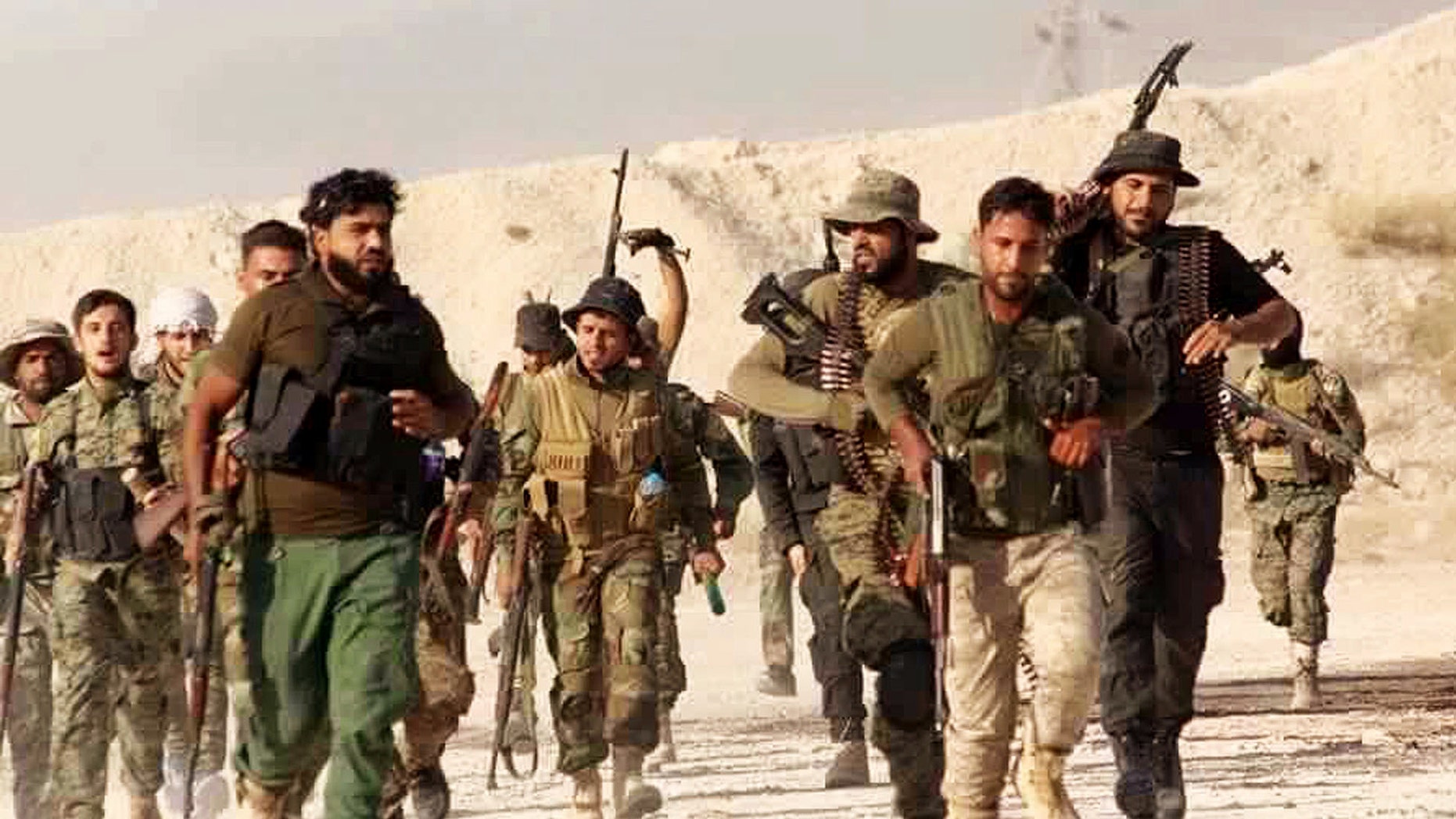 U.S.-backed Syrian rebels of the New Syrian Army march in Syria.
